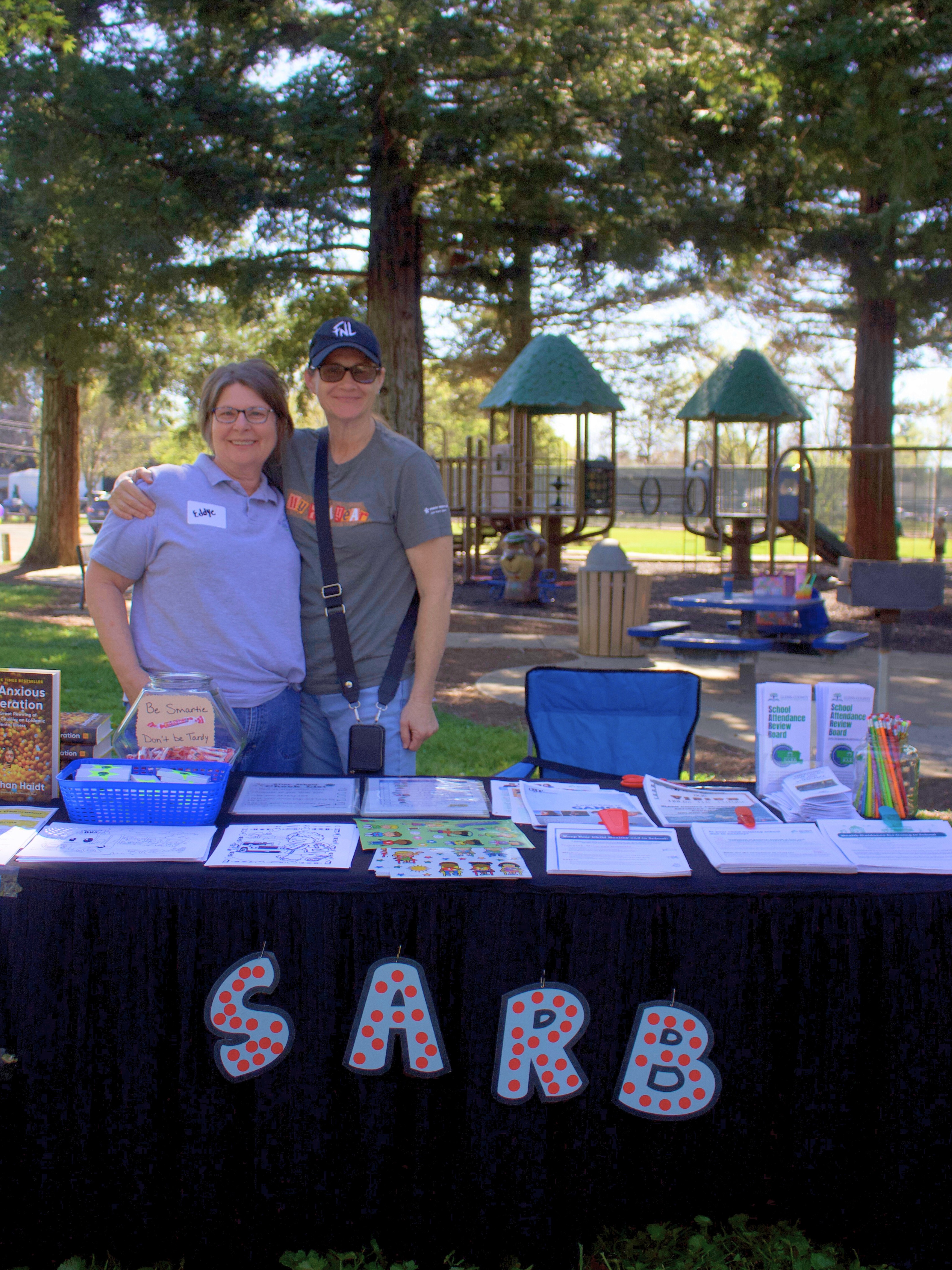 SARB Table at Wellness Walk - two adults smiling