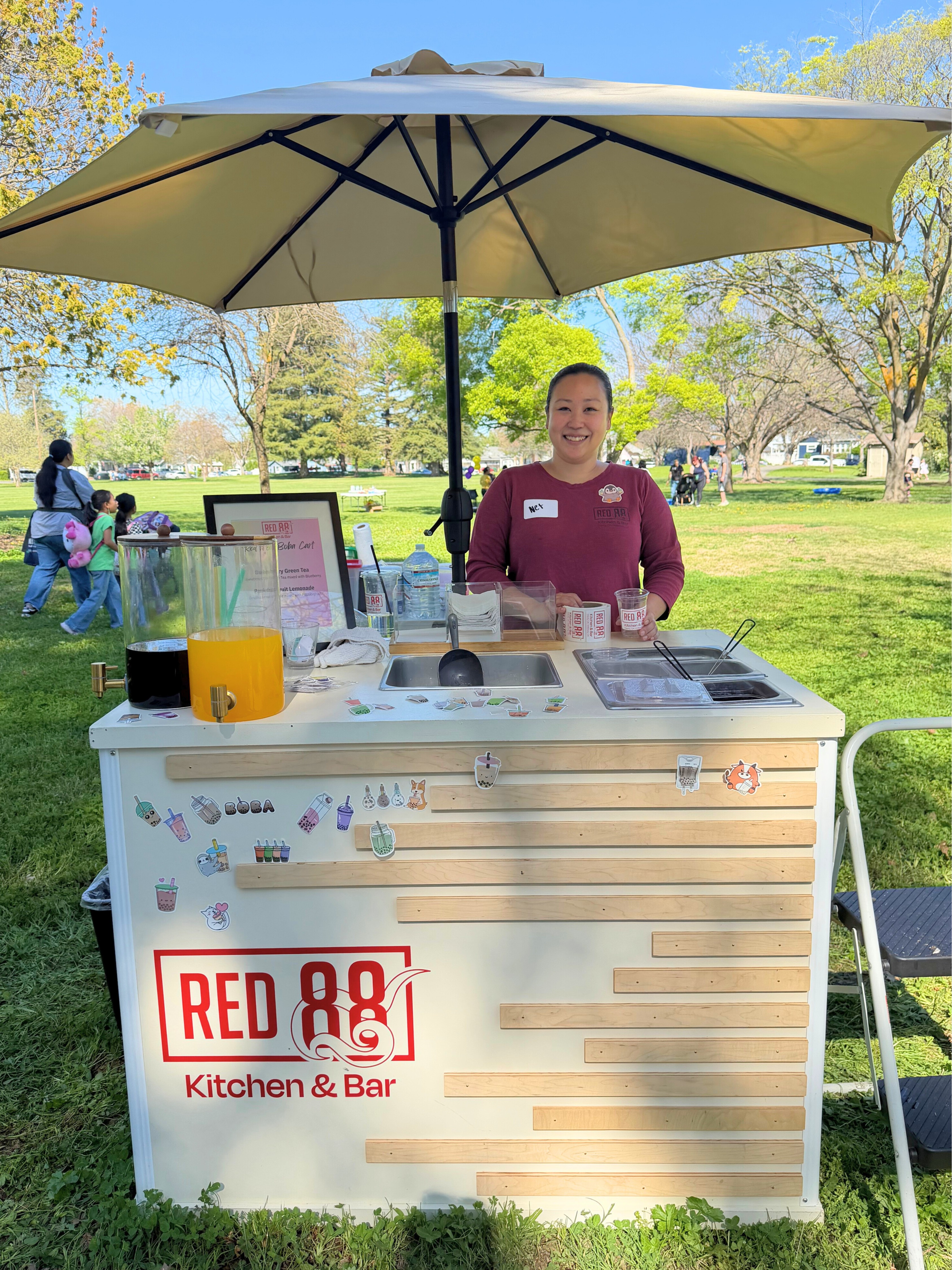 Female attendant at Red 88 Table with beverages