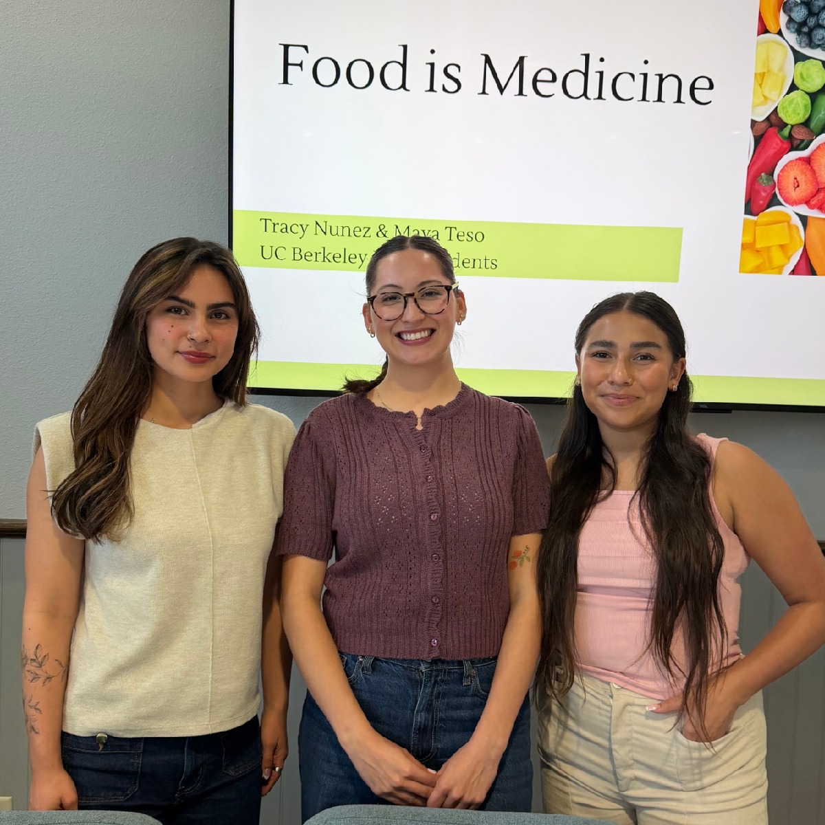 Food is Medicine Workshop, Three females standing in front of presentation board