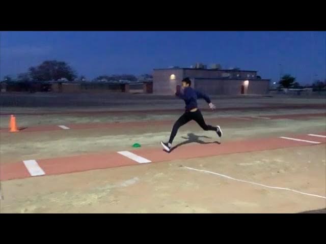 student running on track at night 