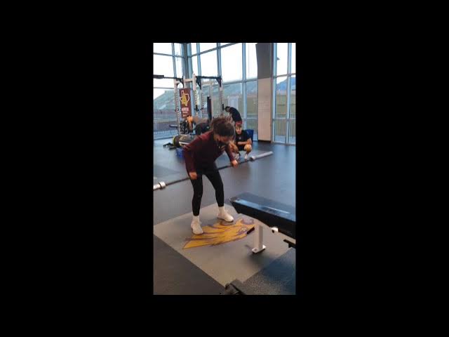 student lifting weights 