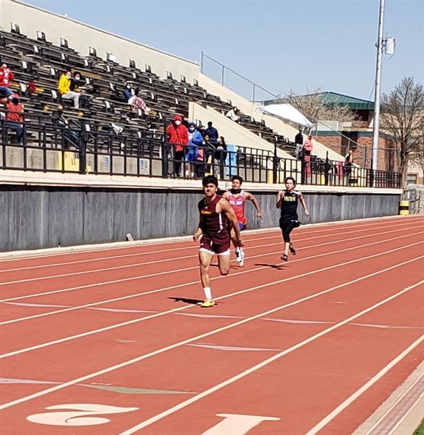 3 students running on track 