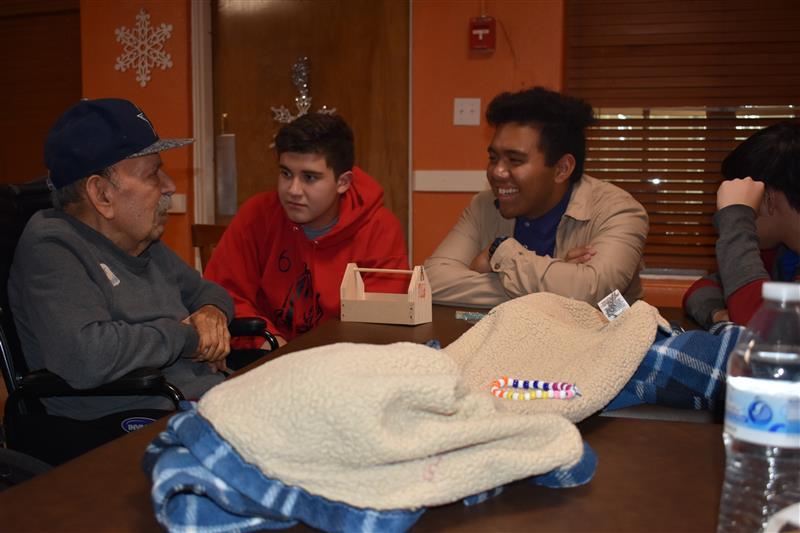 students talking to elderly  people