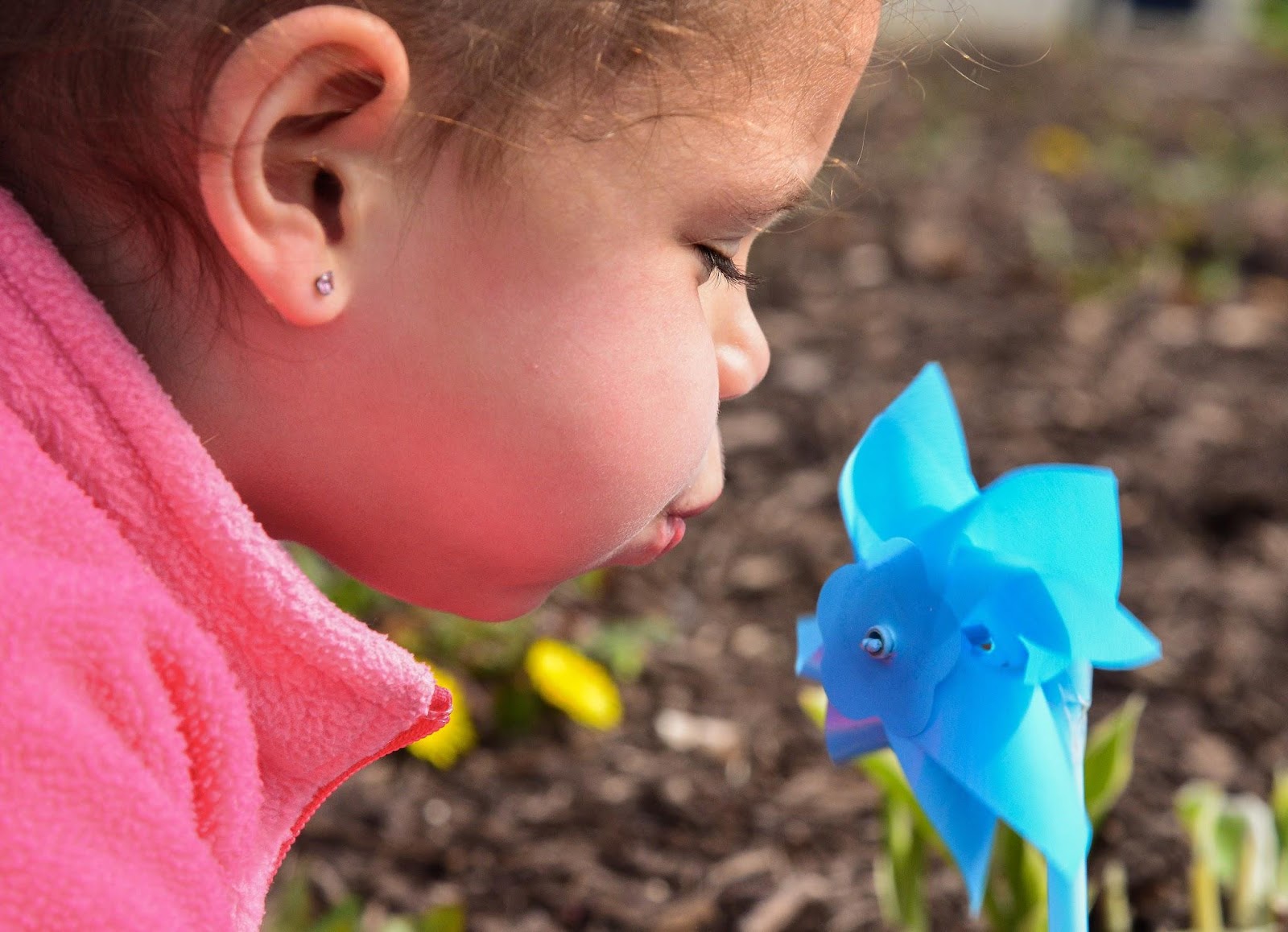 Kid blowing a pinwheel