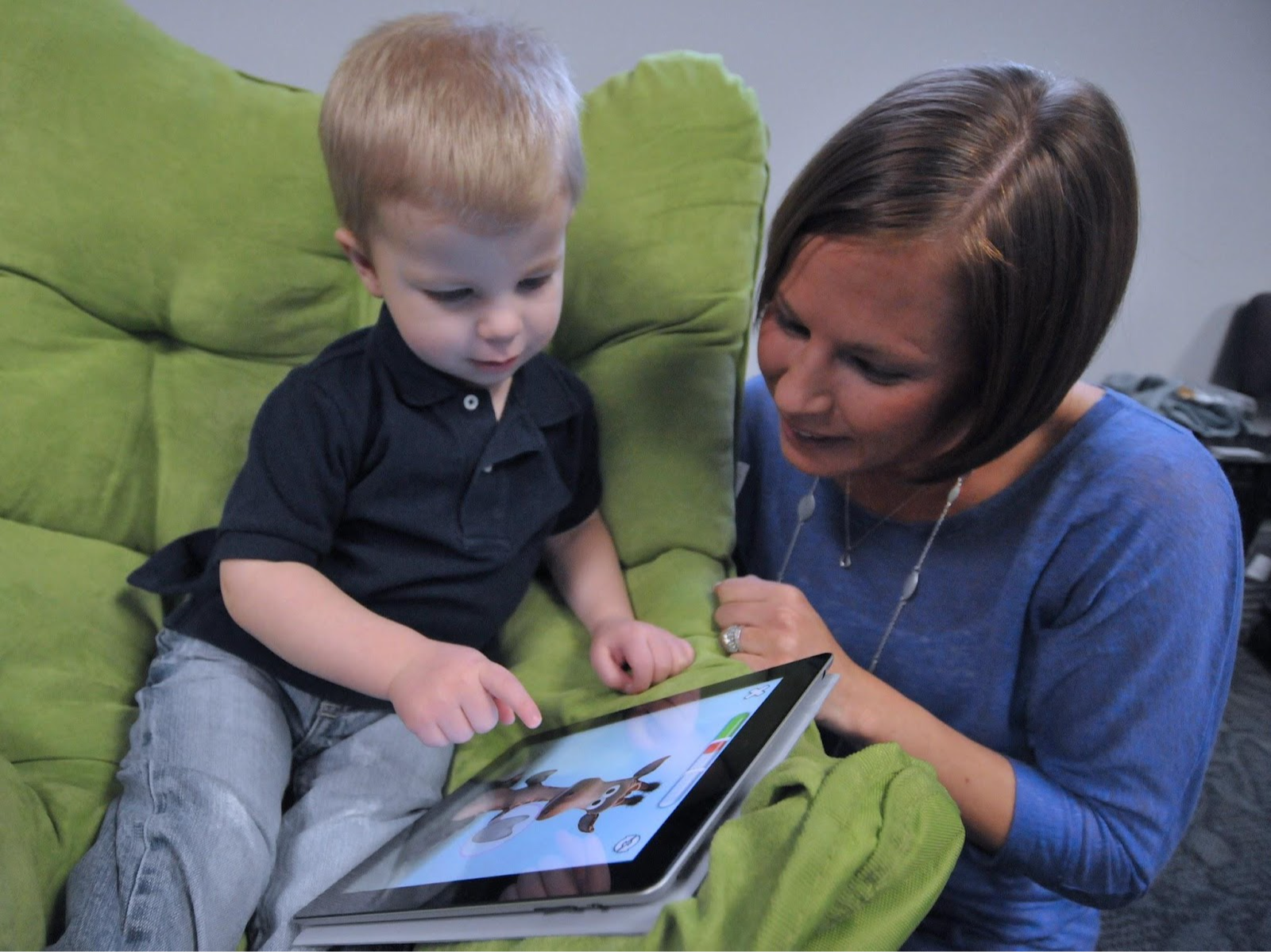 Kid and mom looking at the iPad