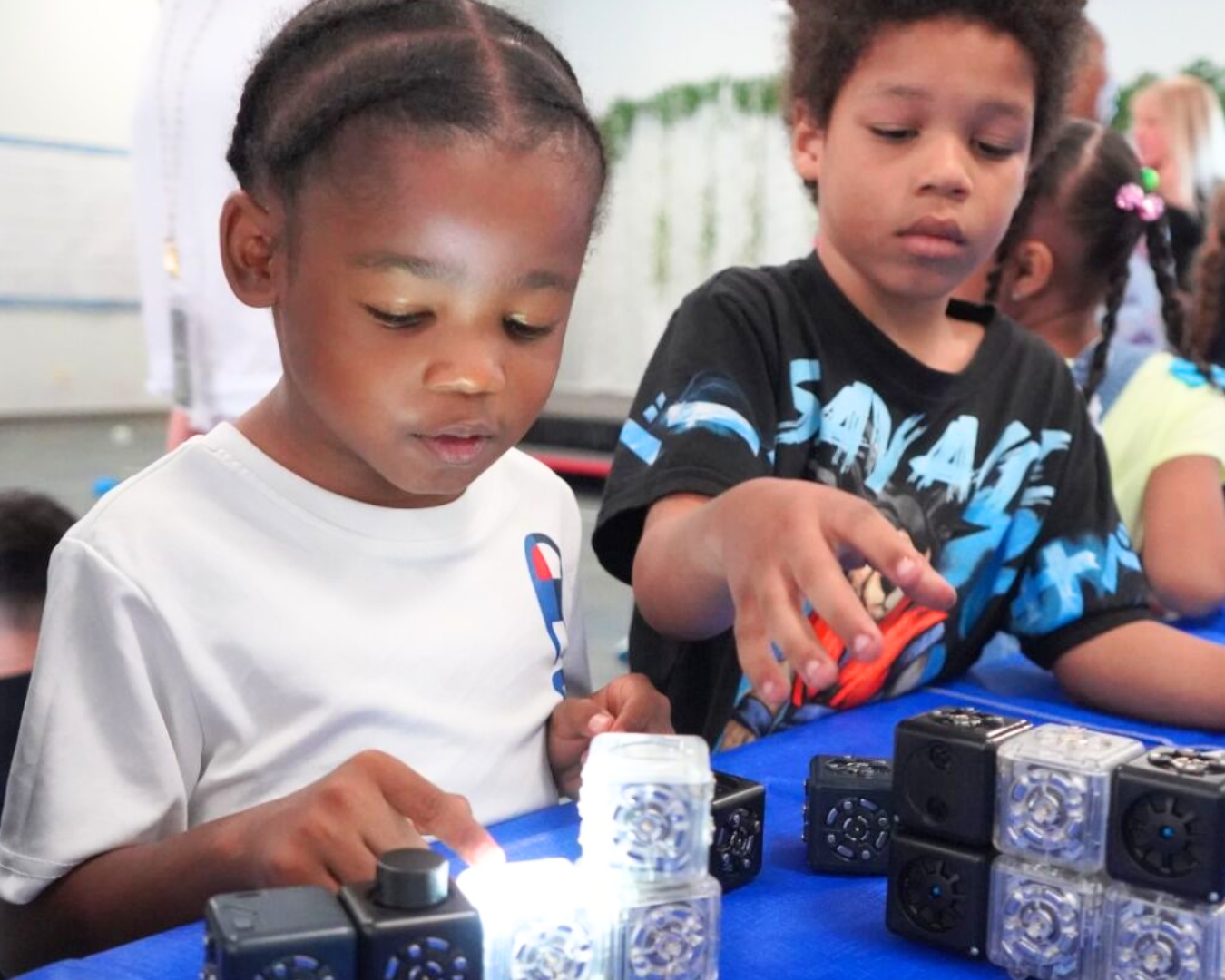 two students playing with robotics