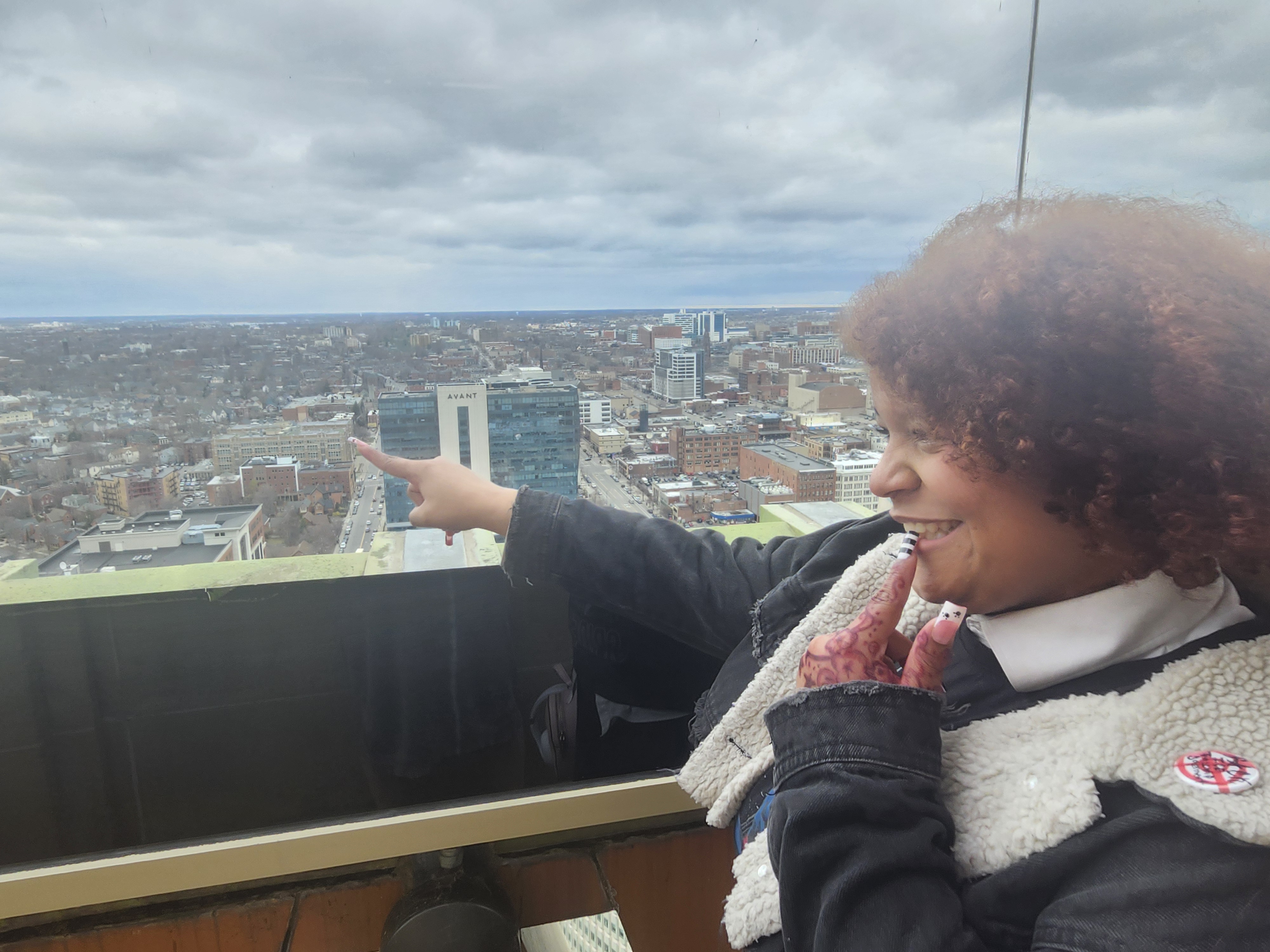 Student at top of Buffalo City Hall looking out at city 