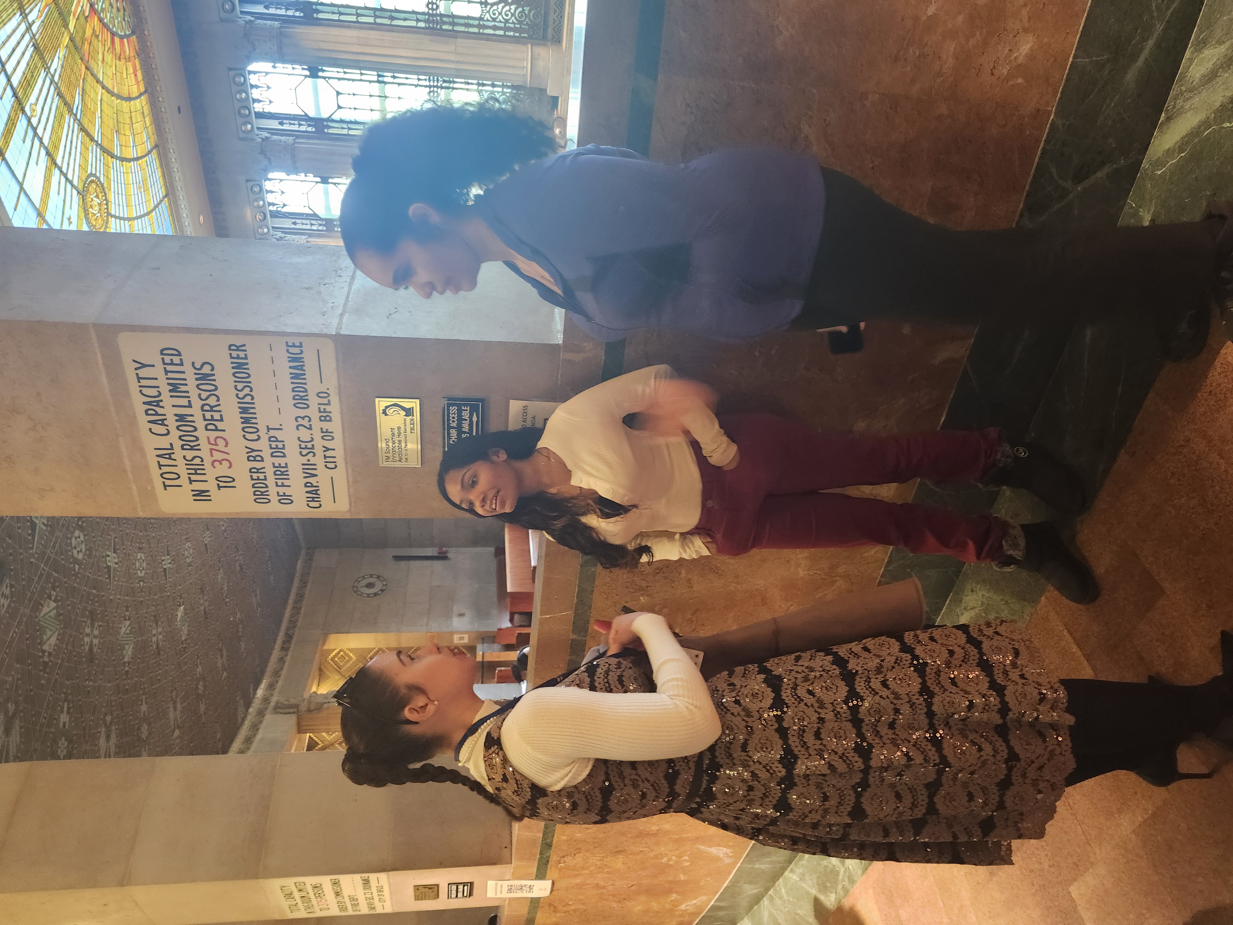 students talking to BPS Board Member T. Rodriguez