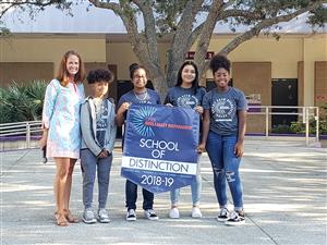 5 Students holding a banner
