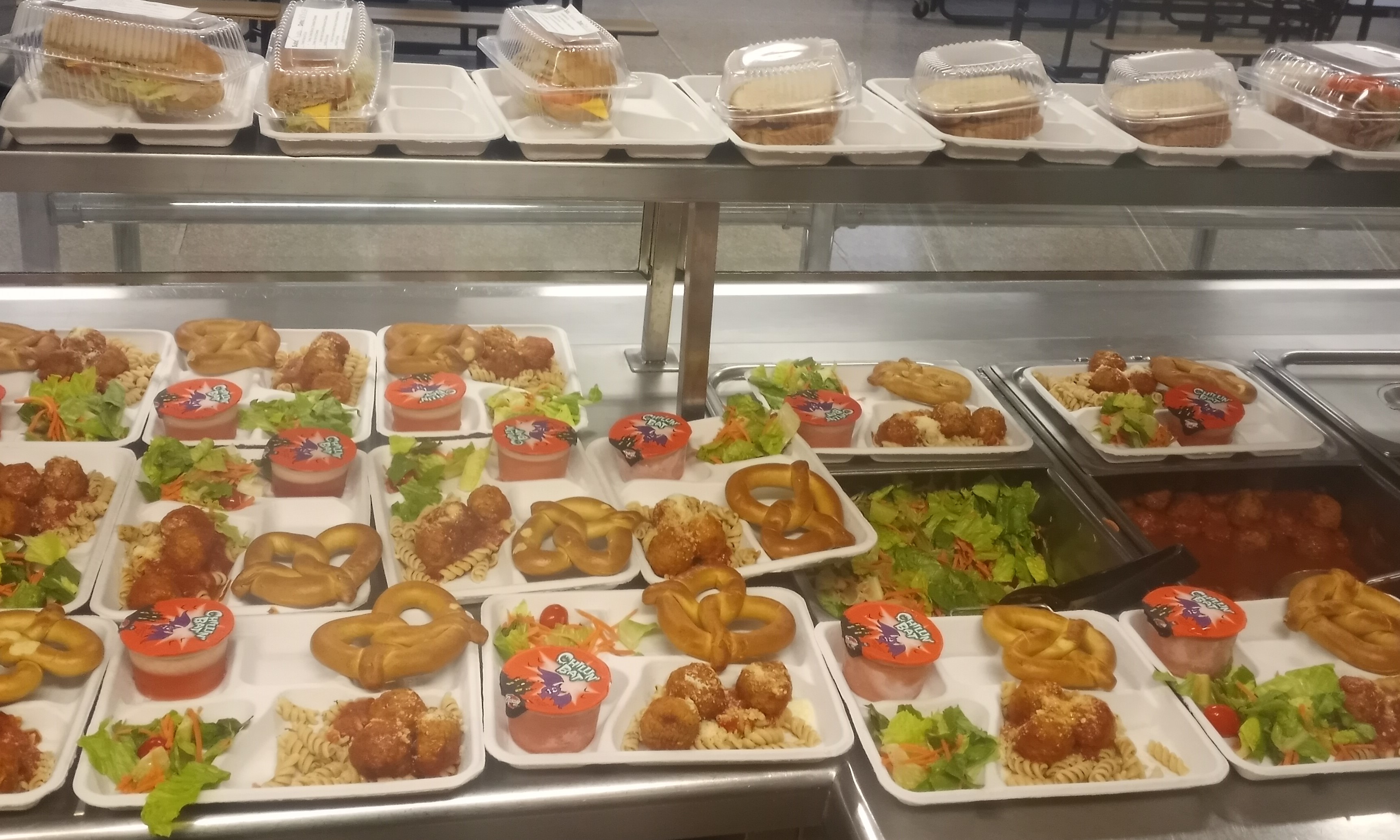 School 207- Serving line Lunch served on 10.31.2024 Halal meatballs over noodle, pretzel, salad & Juice