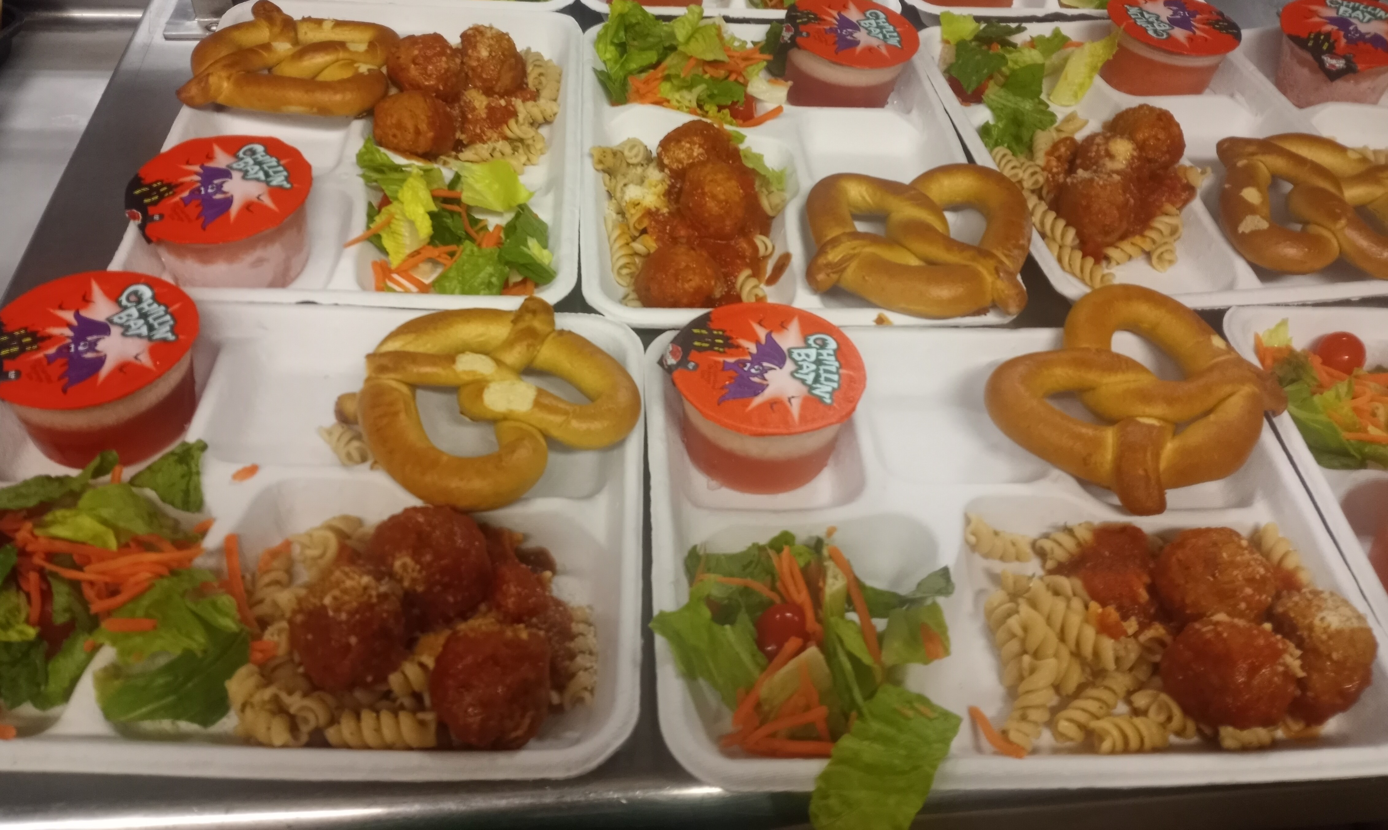 School 207- Lunch served on 10.31.2024 Halal meatballs over noodle, pretzel, salad & Juice