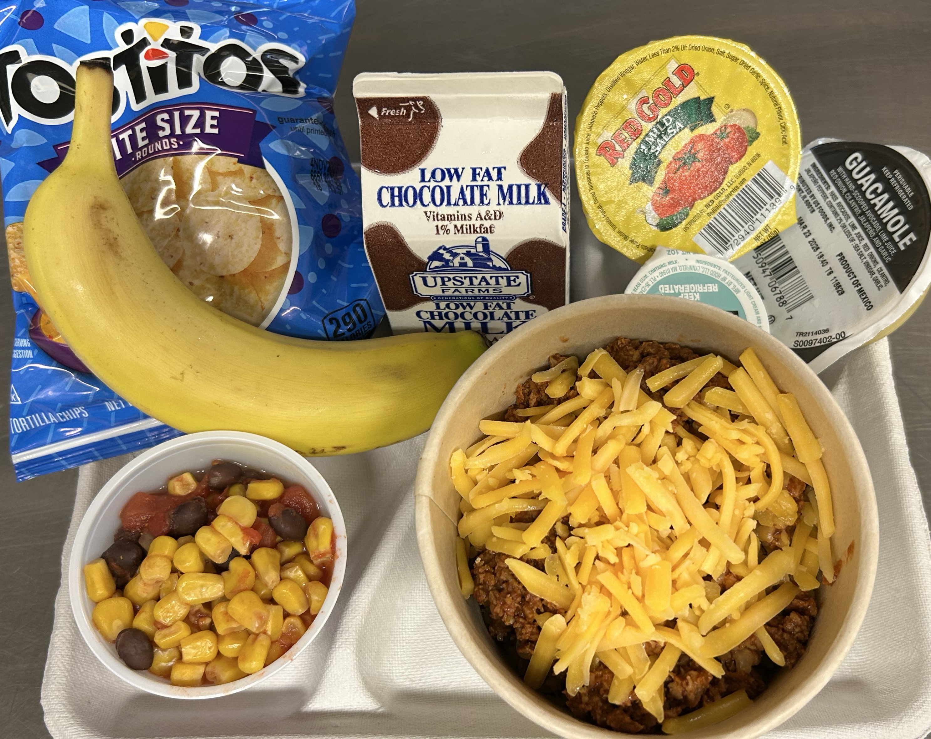 School #6 - Lunch served on 9.23.25 Turkey Taco over Rice Bowl Spanish Rice, Fiesta Corn & Black Beans, Salad, Tostitos, Salsa, Banana  & Chocolate Milk