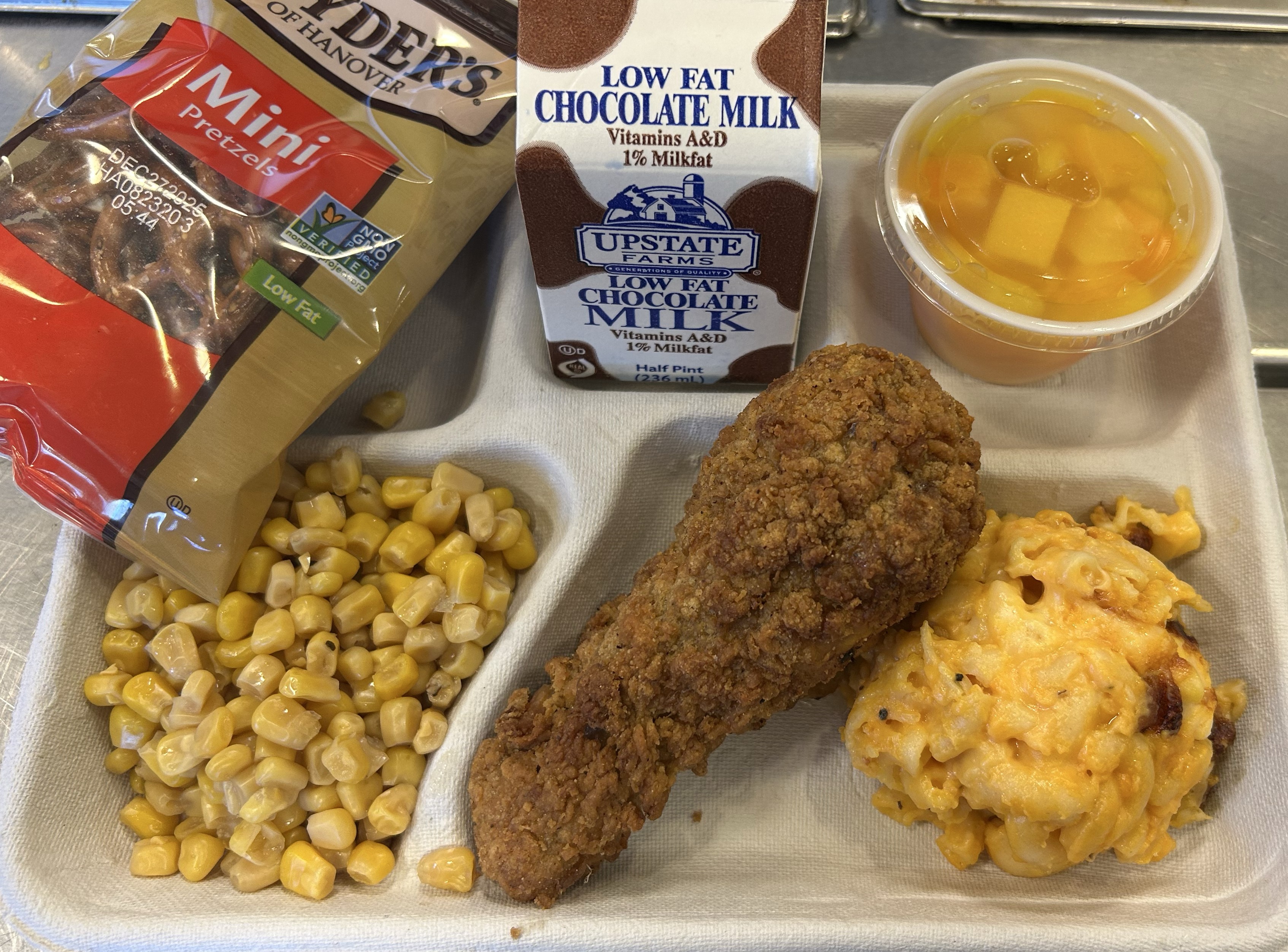 School #7 - Lunch served on 9.17.25 Breaded Chicken Drumstick, Macaroni & Cheese, Pretzels, Sweet Corn, Peaches & Chocolate Milk