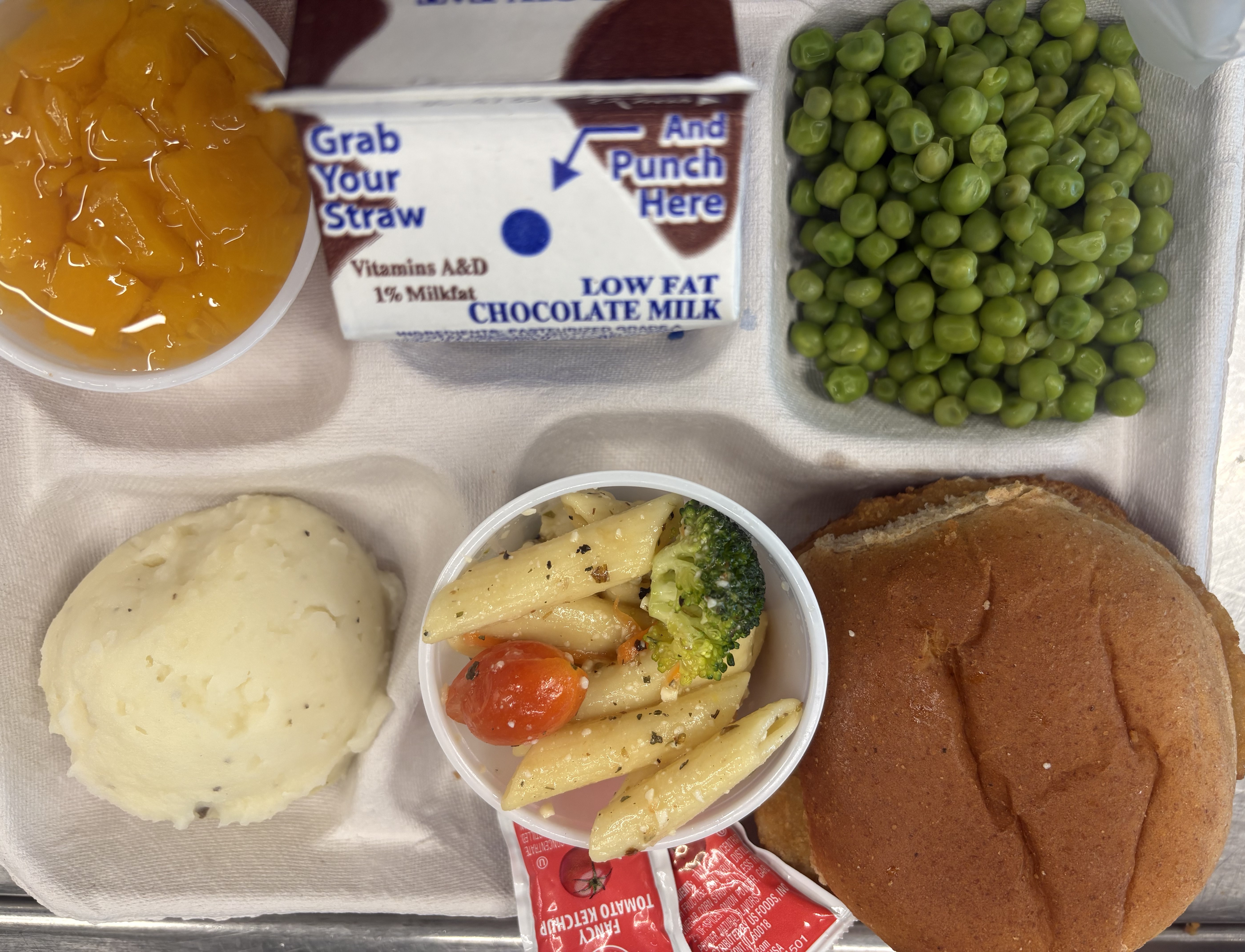 School #8 - Lunch served on 9.22.25 Plant Based Chk'n Patty, WG Burger bun, Pasta Salad, Mashed Potatoes, Green Peas, Peaches & Chocolate Milk