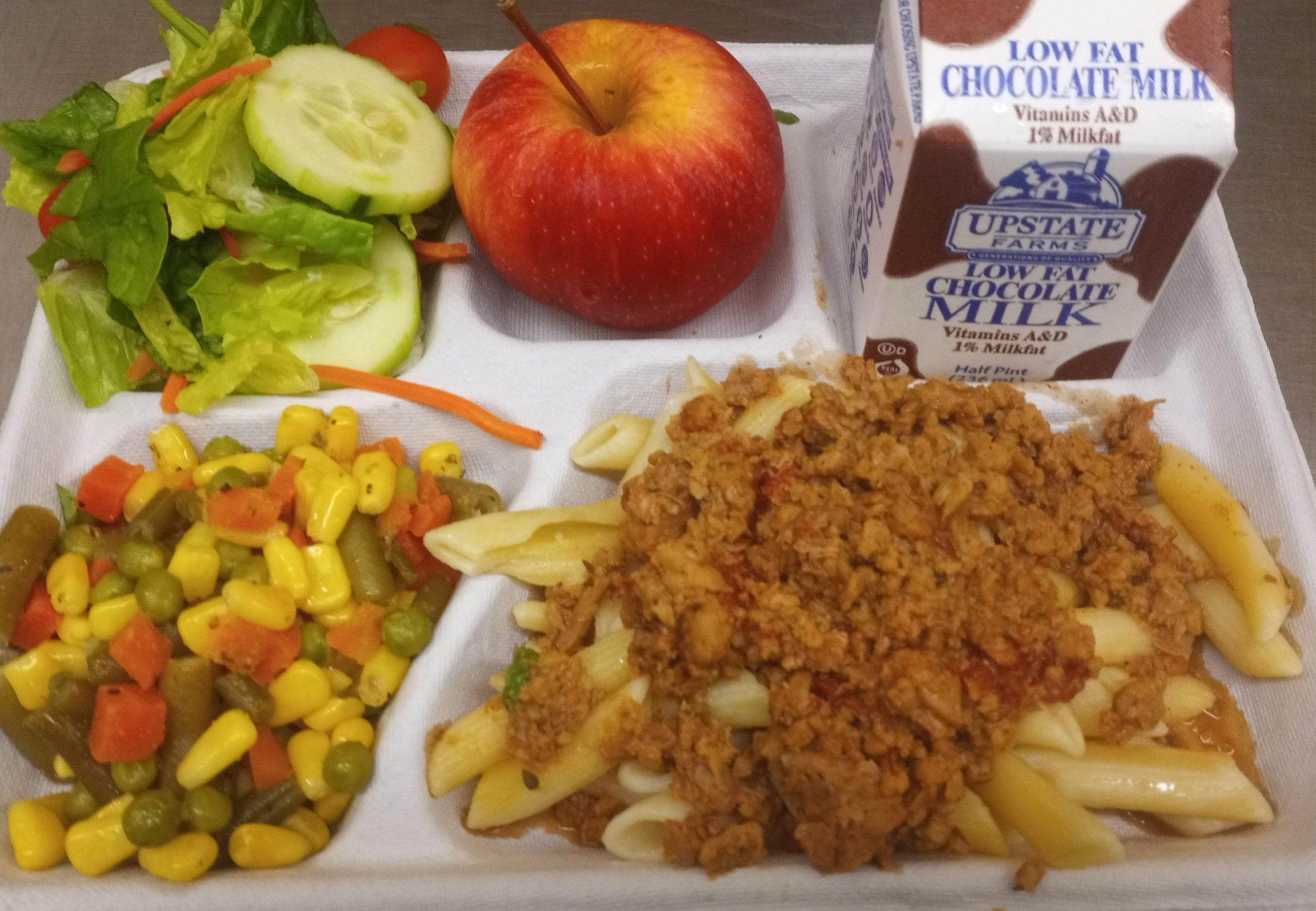 School #11- Lunch served on 9.18.25 NY Plant based Bolognese, WG Penne Pasta, Garden Salad, Vegetable Medley, Apple & Chocolate Milk