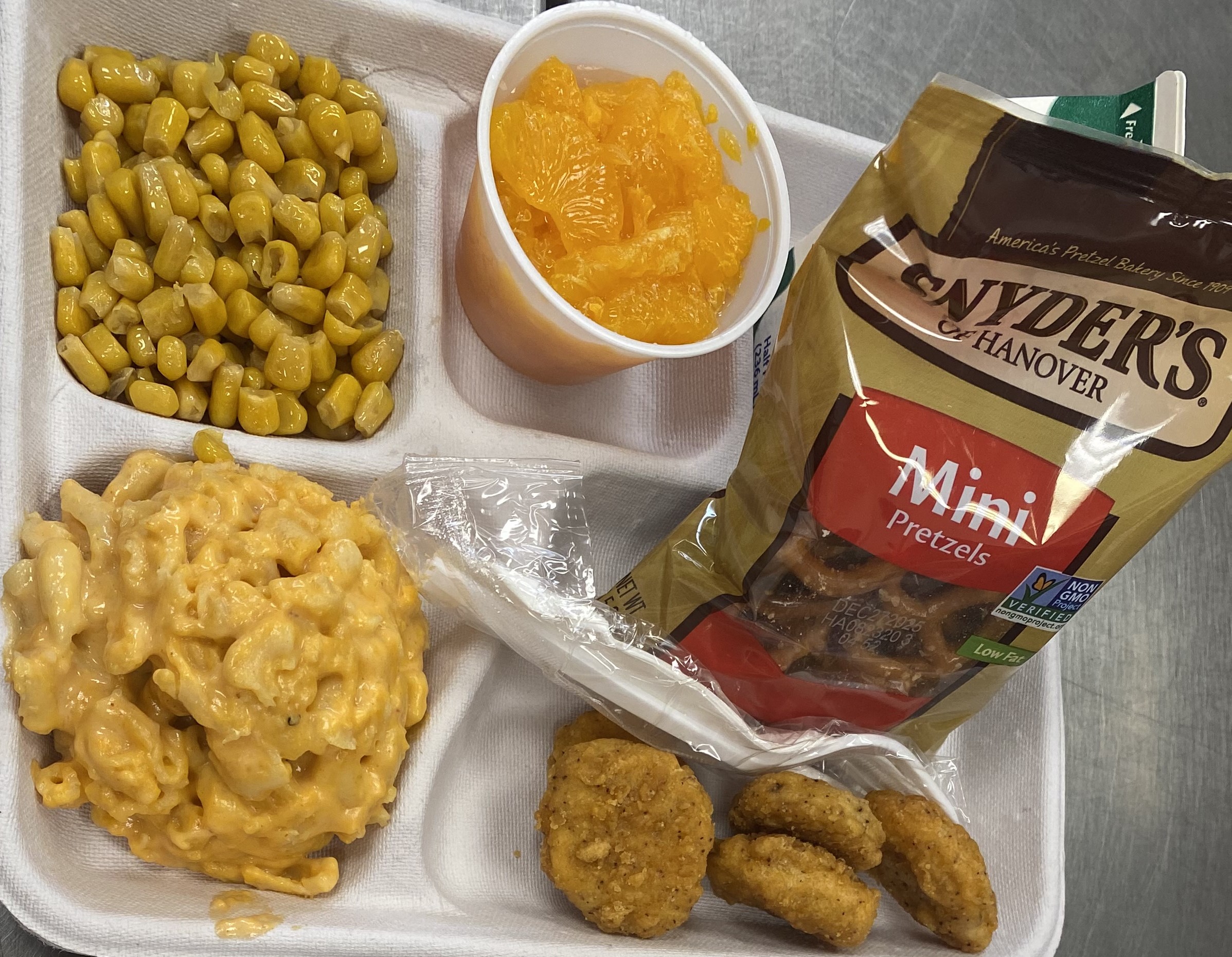 School #13 - Lunch served on 9.17.25 Nuggets, Macaroni & Cheese, Pretzels, Sweet Corn, Tangerine & Milk