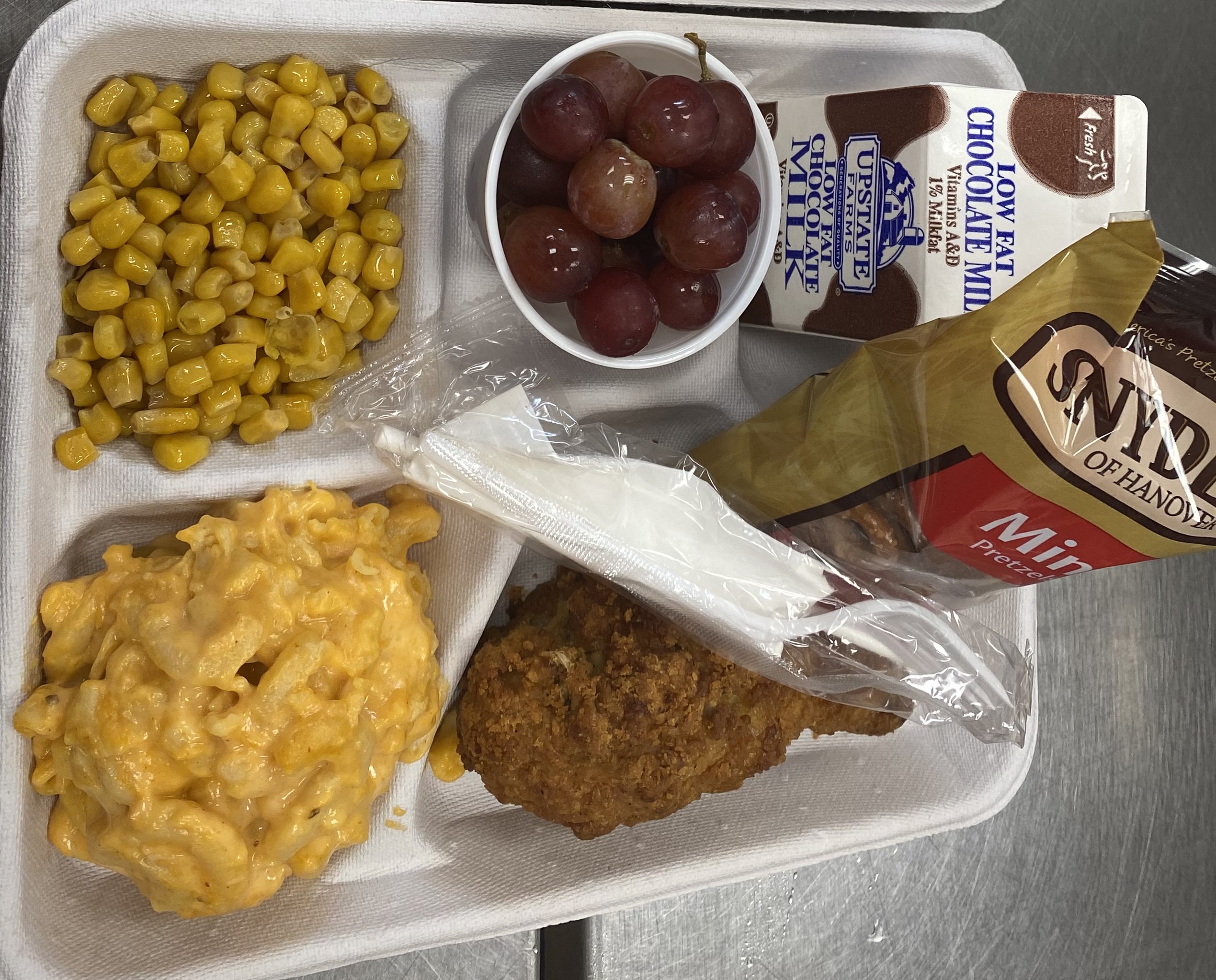 School #14 - Lunch served on 9.17.25 Breaded Chicken Drumstick, Macaroni & Cheese, Pretzels, Sweet Corn, Grapes & Chocolate Milk