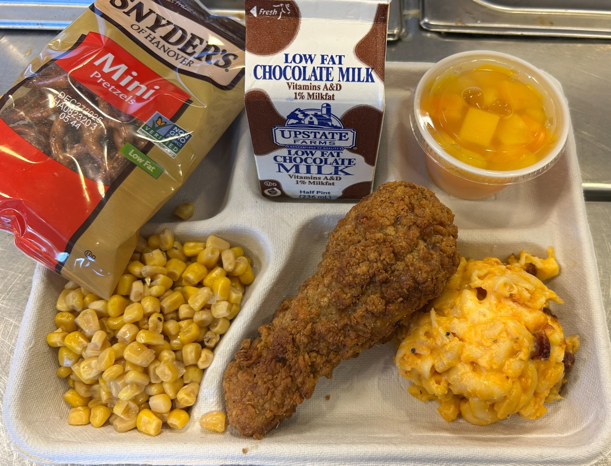 School #16 - Lunch served on 9.17.25 Breaded Chicken Drumstick, Macaroni & Cheese, Pretzels, Sweet Corn, Peaches & Chocolate Milk