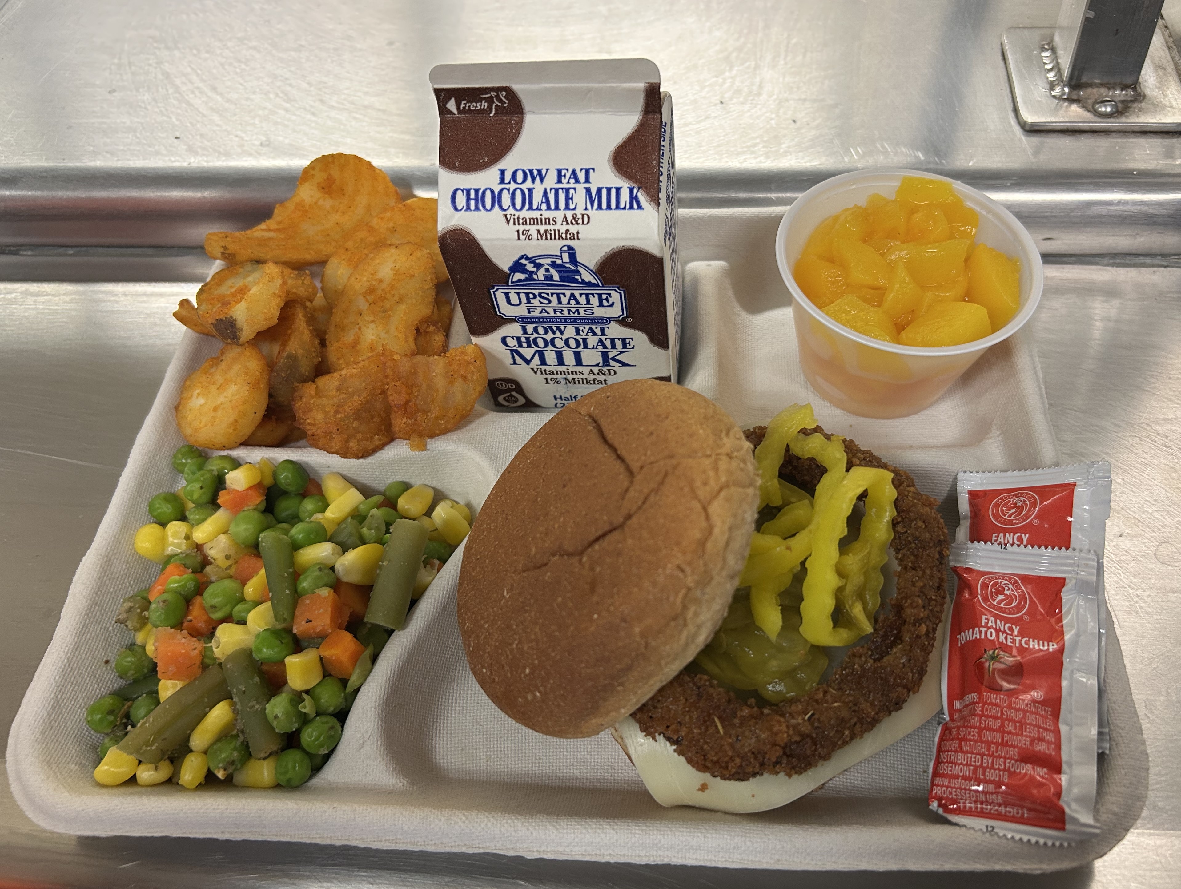 School #22 Rodeo Burger, twisted tators, vegetable medley, peaches and chocolate milk