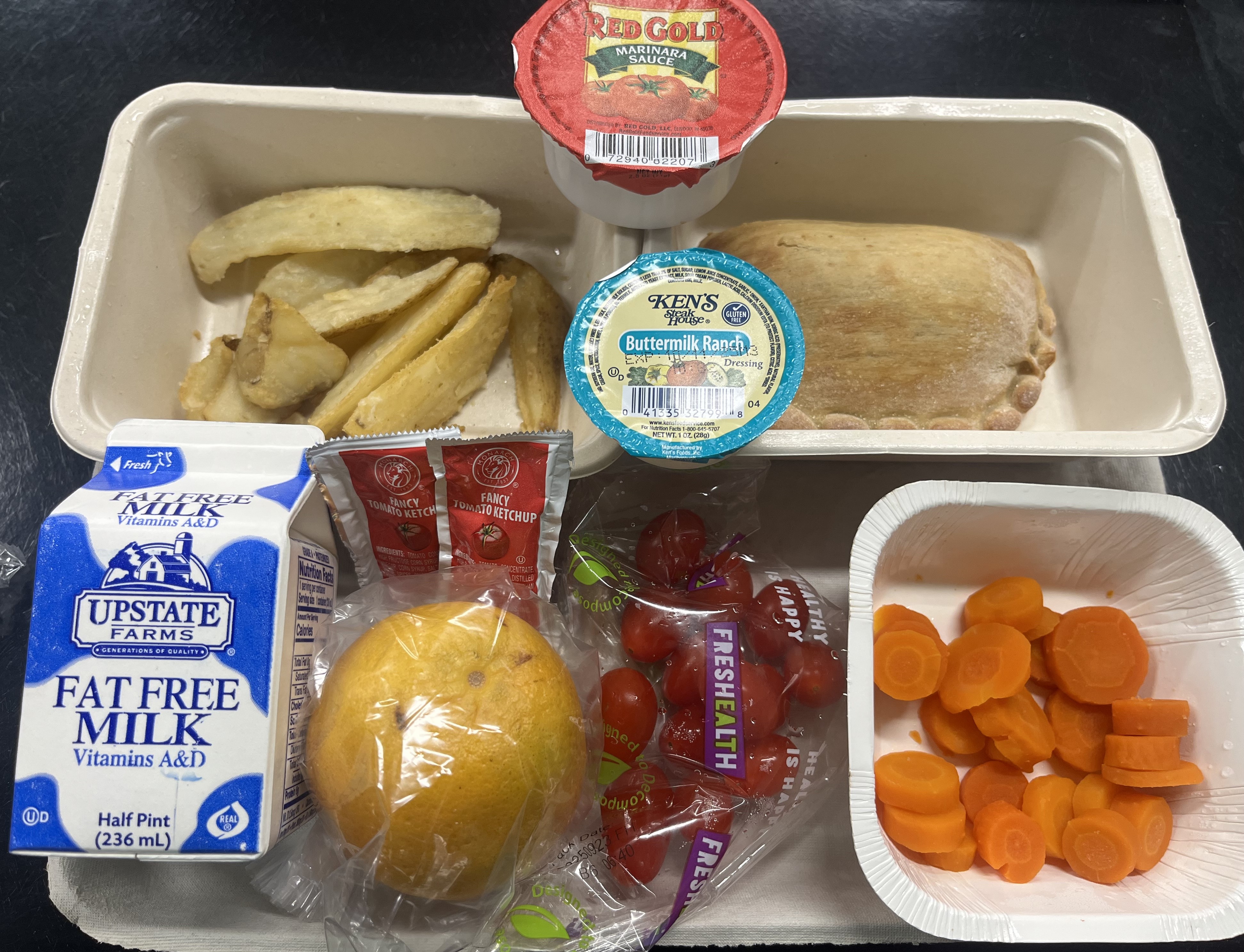 Reach Annex- Prepack lunch served 10.2.25 Cheese Calzone, Rosemary potatoes, Carrot coins, Cherry tomatoes, Orange & Milk
