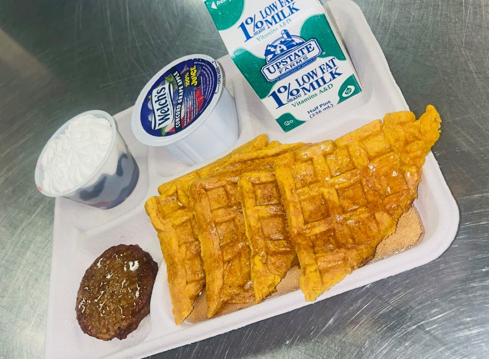 School 198- Lunch served on 10.2.25 NY Carrot Waffles, Plant-based breakfast sausage, Grape Apple juice, Mixed Berry cup-whipped cream, Baked flaming Cheetos & Chocolate Milk