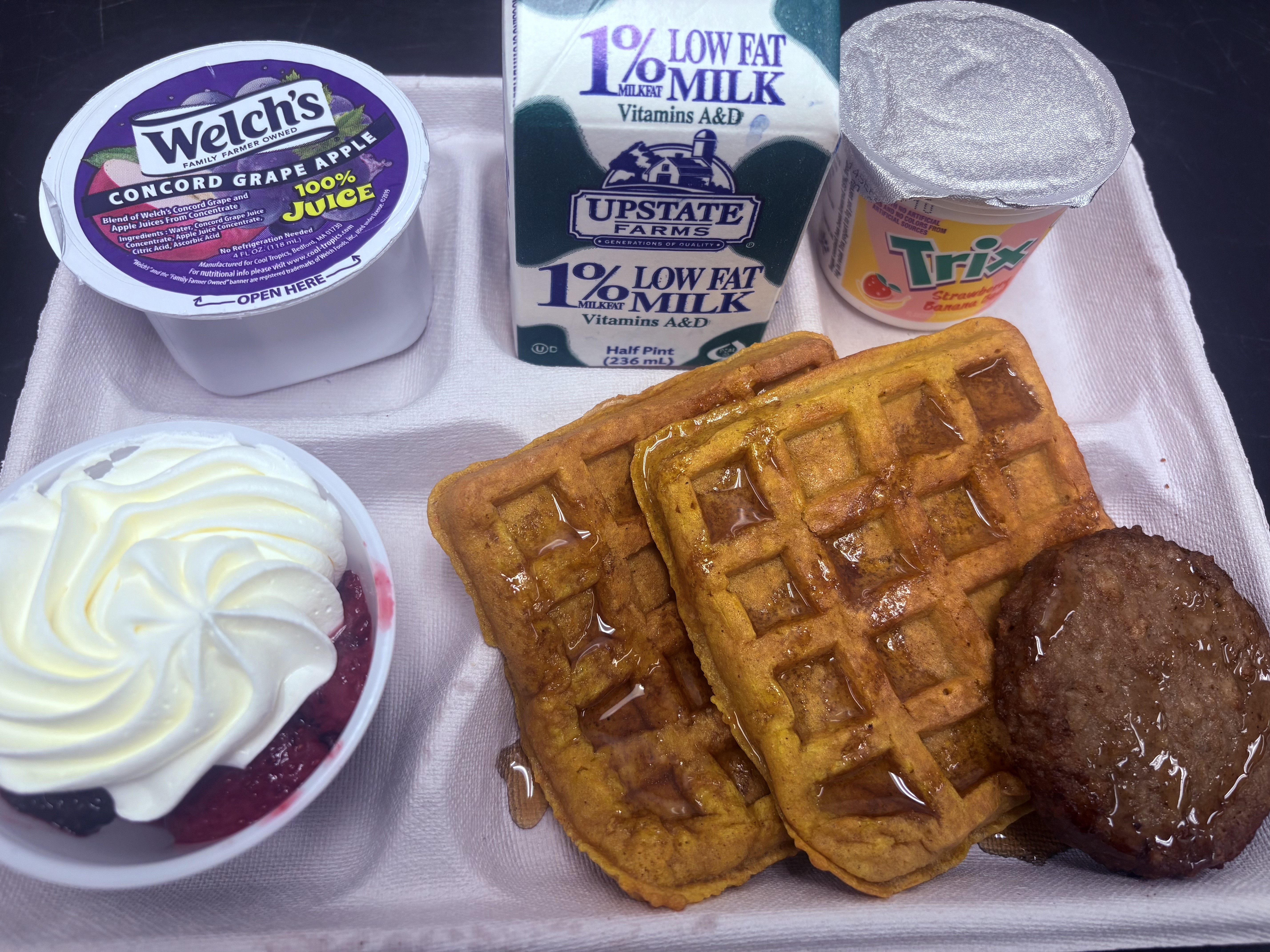 School 50- Lunch served on 10.2.25 NY Carrot Waffles, Plant-based breakfast sausage, Grape Apple juice, Mixed Berry cup-whipped cream, Strawberry-banana yogurt & Milk