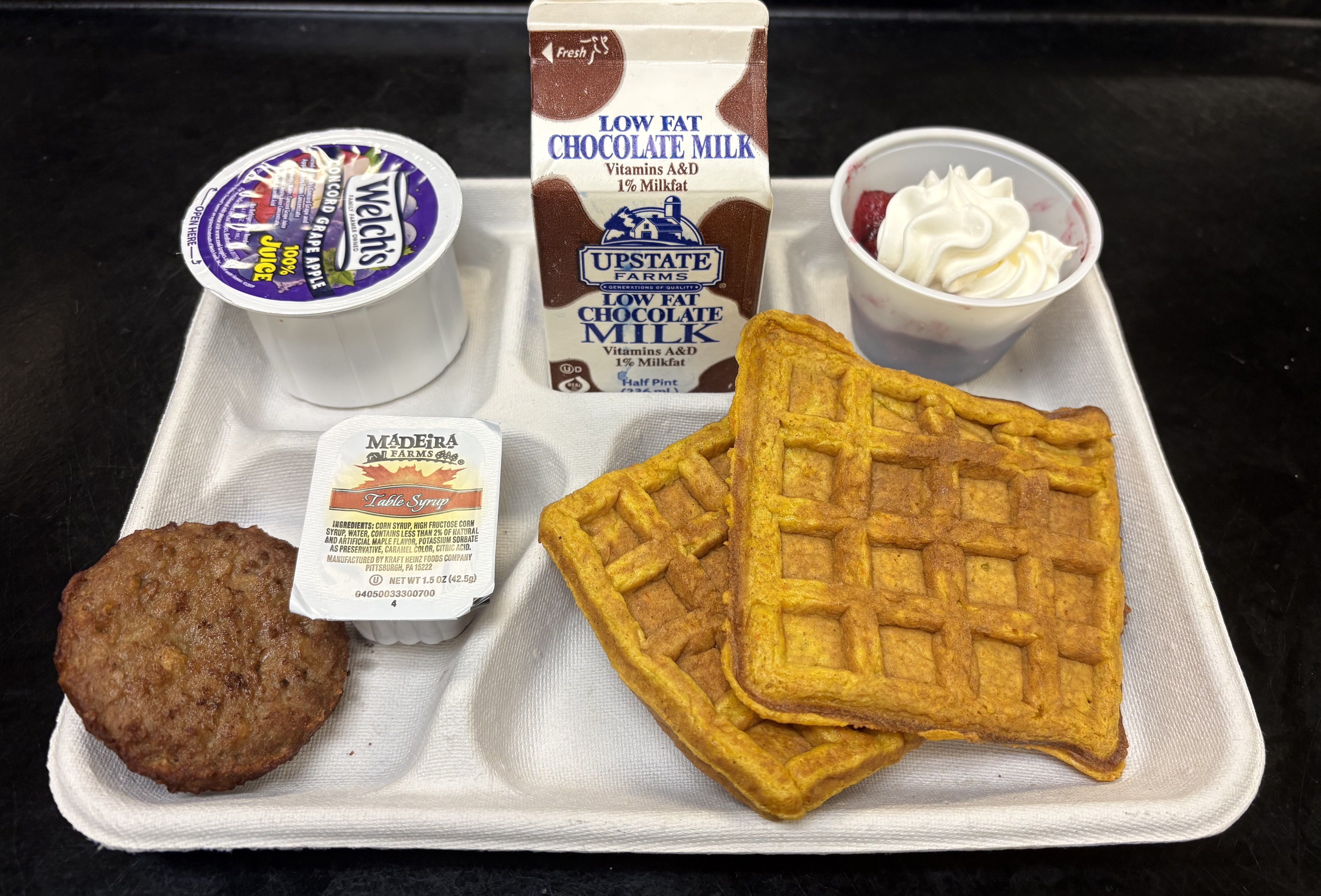 School 72- Lunch served on 10.2.25 NY Carrot Waffles, Plant-based breakfast sausage, Grape Apple juice, Mixed Berry cup-whipped cream, & Chocolate Milk