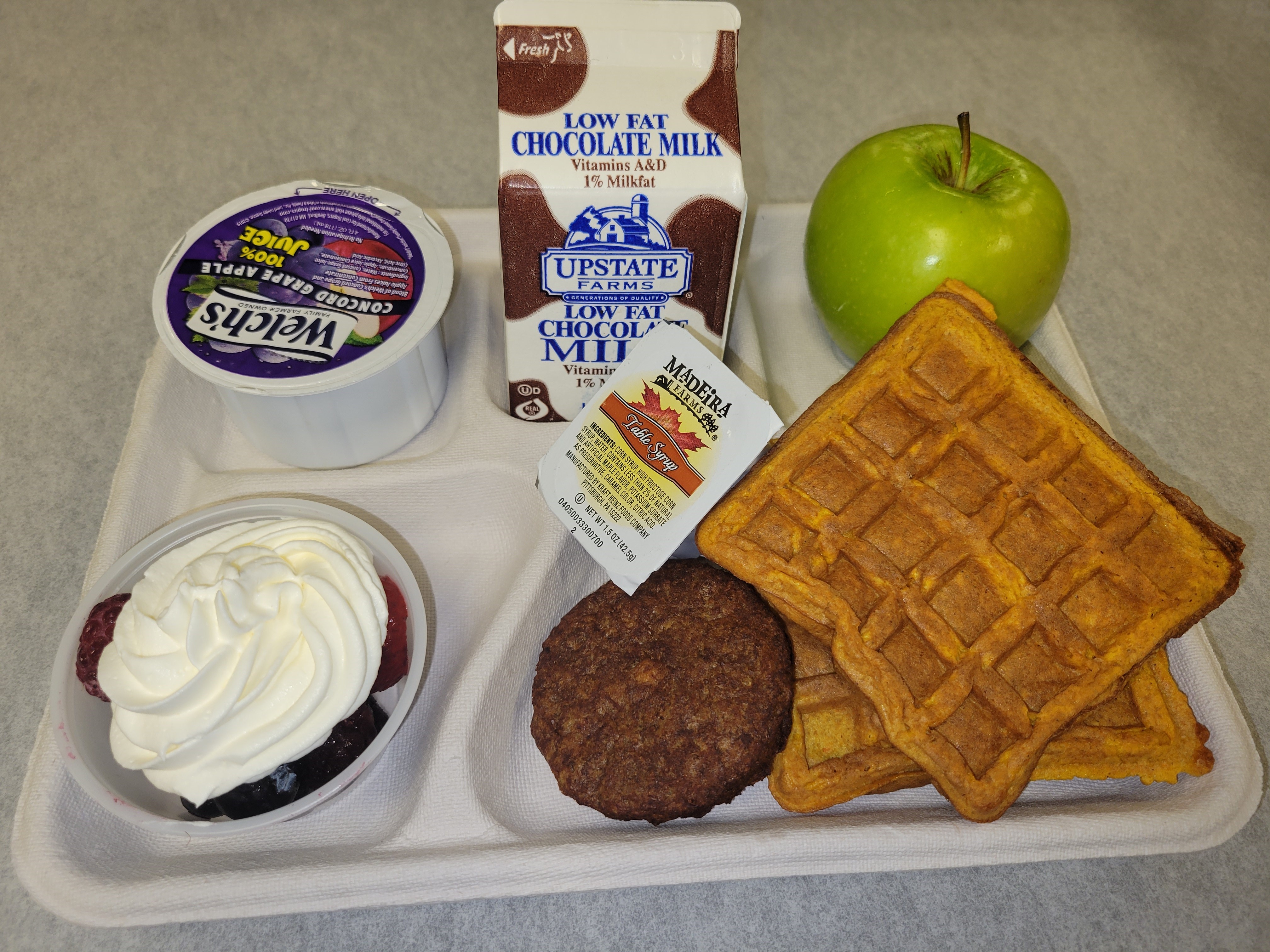 School 33- Lunch served on 10.2.25 NY Carrot Waffles, Plant-based breakfast sausage, Grape Apple juice, Mixed Berry cup-whipped cream, Apple & Chocolate Milk