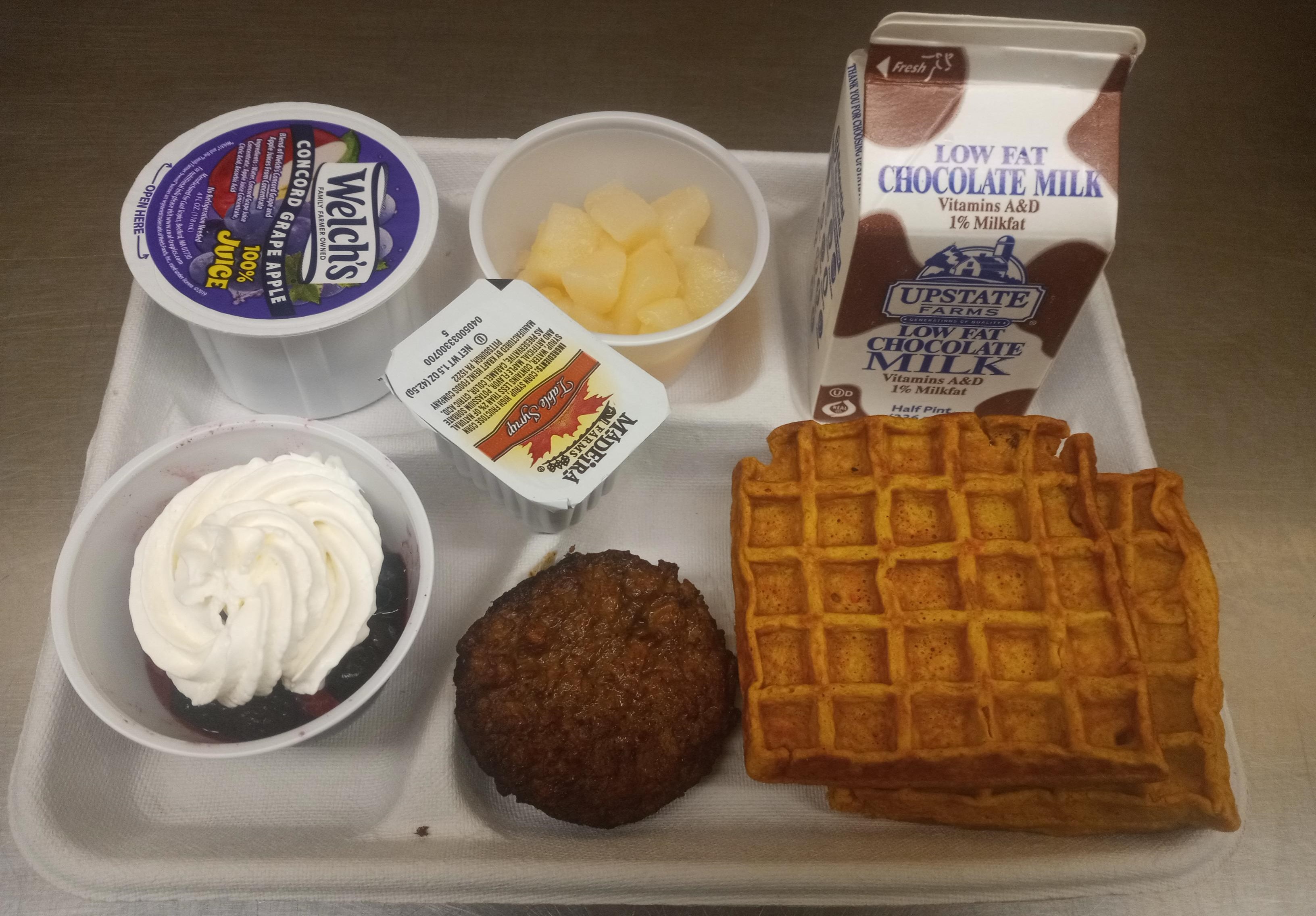 School 207- Lunch served on 10.2.25 NY Carrot Waffles, Plant-based breakfast sausage, Mixed Berry cup-whipped cream, Pears, Grape-Apple Juice & Chocolate Milk