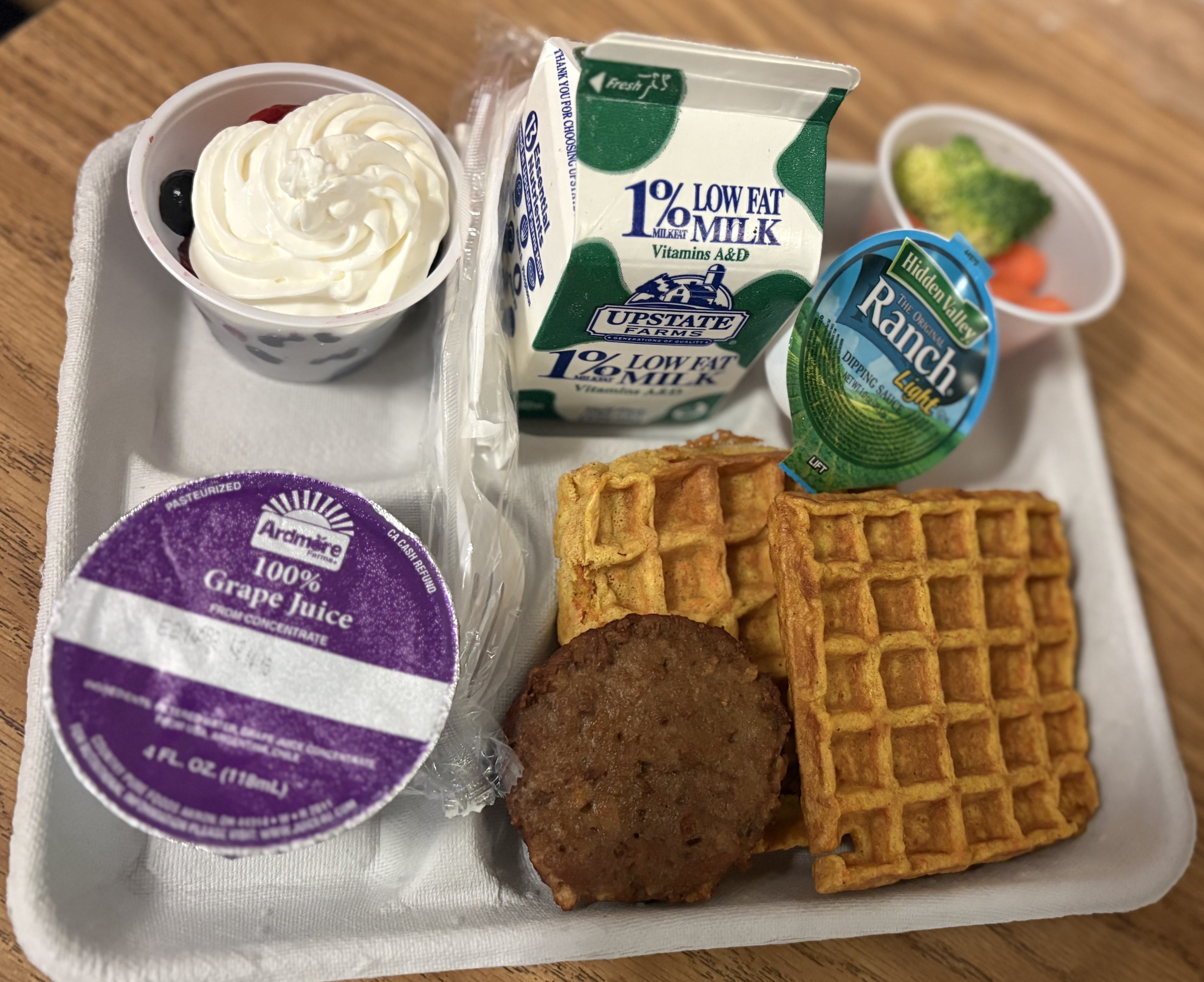School 32- Lunch served on 10.2.25 NY Carrot Waffles, Plant-based breakfast sausage, Grape juice, Broccoli-carrots cup, Mixed Berry cup-whipped cream, & Milk