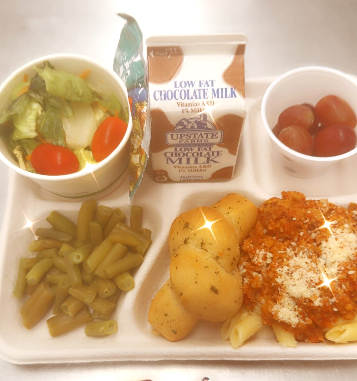 School 95 - Lunch served 10.3.2025 Plant Based Bolognese, Garden salad, Green Beans, Garlic Knots, Grapes & Chocolate Milk
