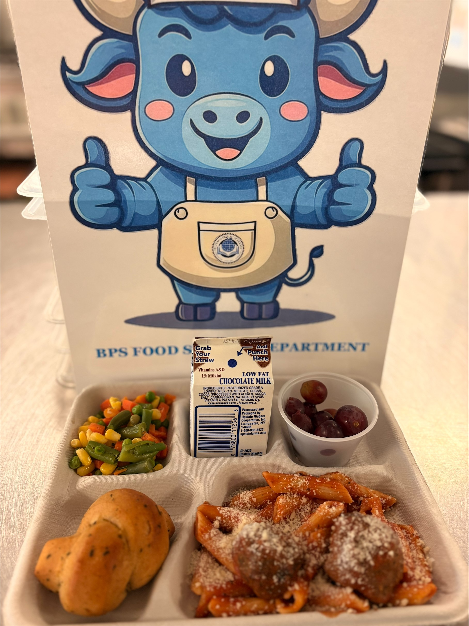 School 198- Lunch served 10.3.2025 Penne pasta with Meatballs & Marinara, Vegetable medley, Grapes, Garlic Knot & Chocolate Milk