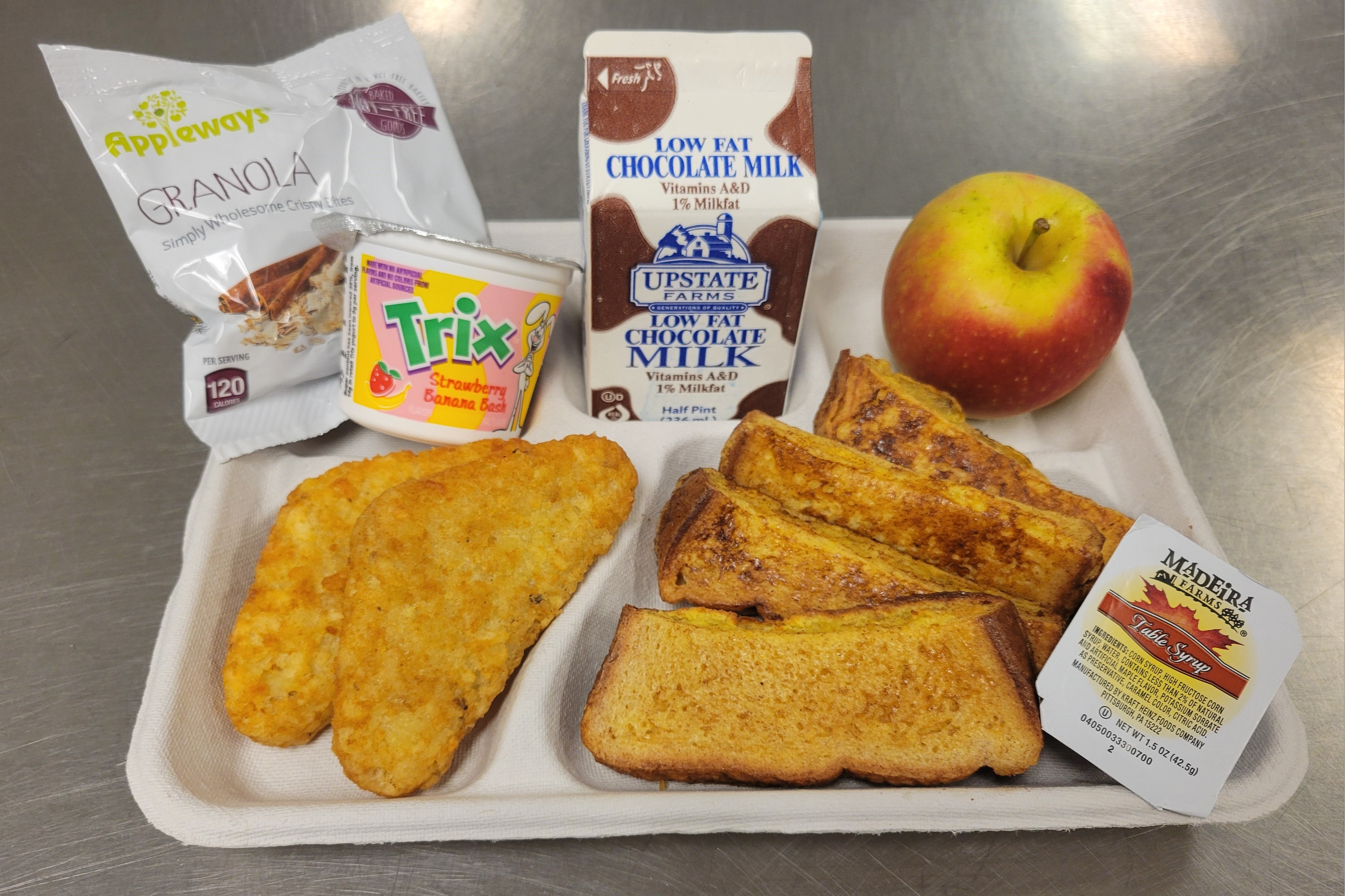 School 33- Lunch served 10.6.2025 French Toast Sticks, Maple Syrup, Hashbrown, Cinnamon Granola Bites, Strawberry Banana Yogurt, Apple & Chocolate Milk