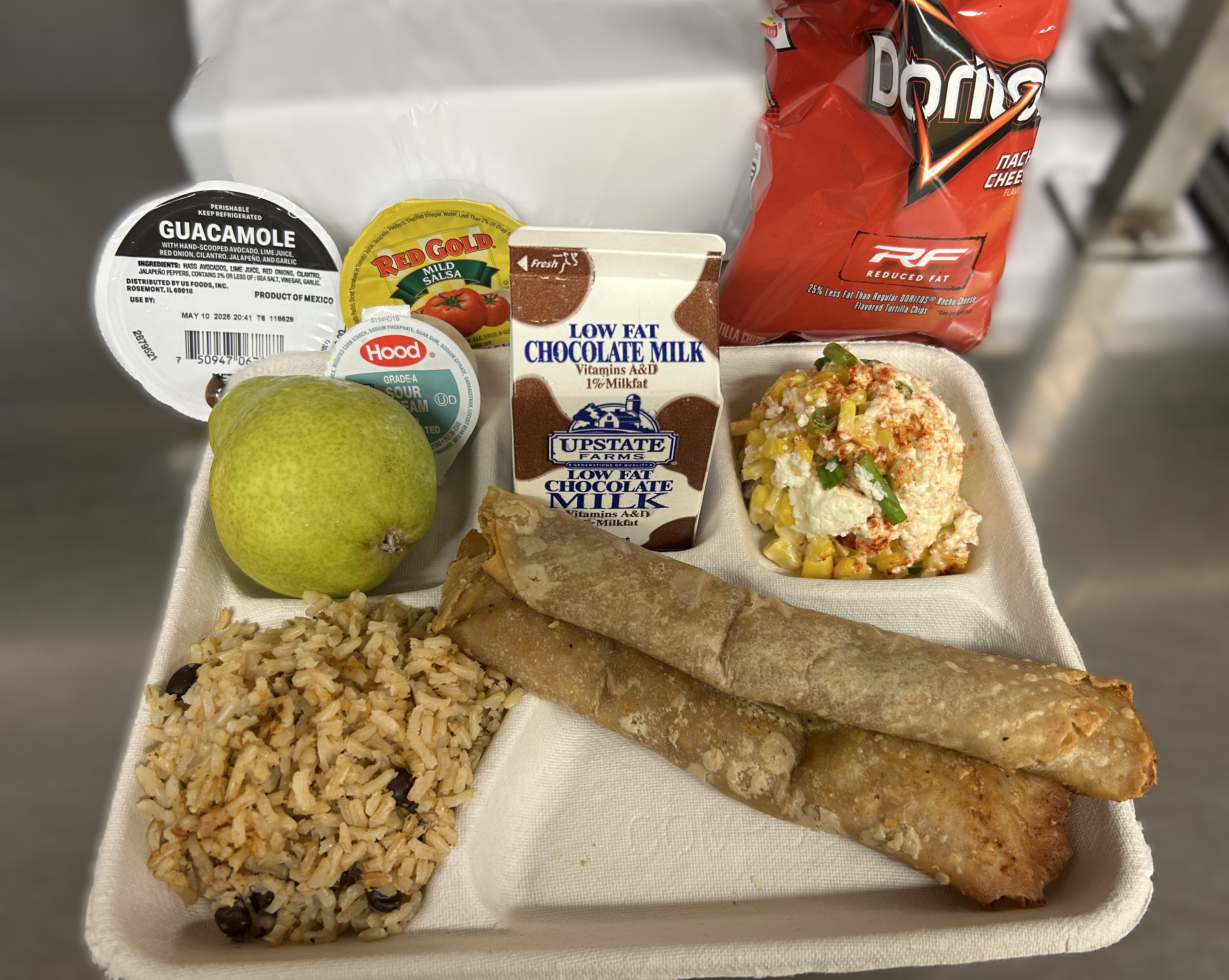 School 207- Lunch served on 10.7.2025 Chicken Crispito, Spanish Rice, Esquites, Salsa, Pear & Chocolate Milk