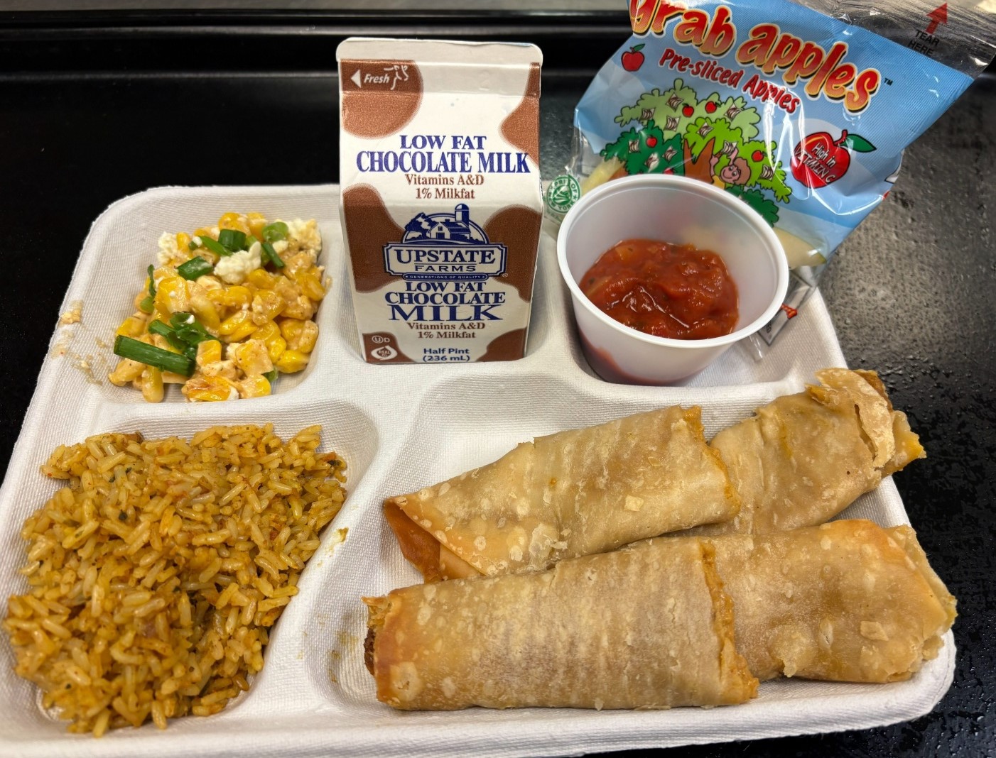 School 72-Lunch served on 10.7.2025 Chicken Crispito, Spanish Rice, Esquites, Salsa, Apple Slices & Chocolate Milk