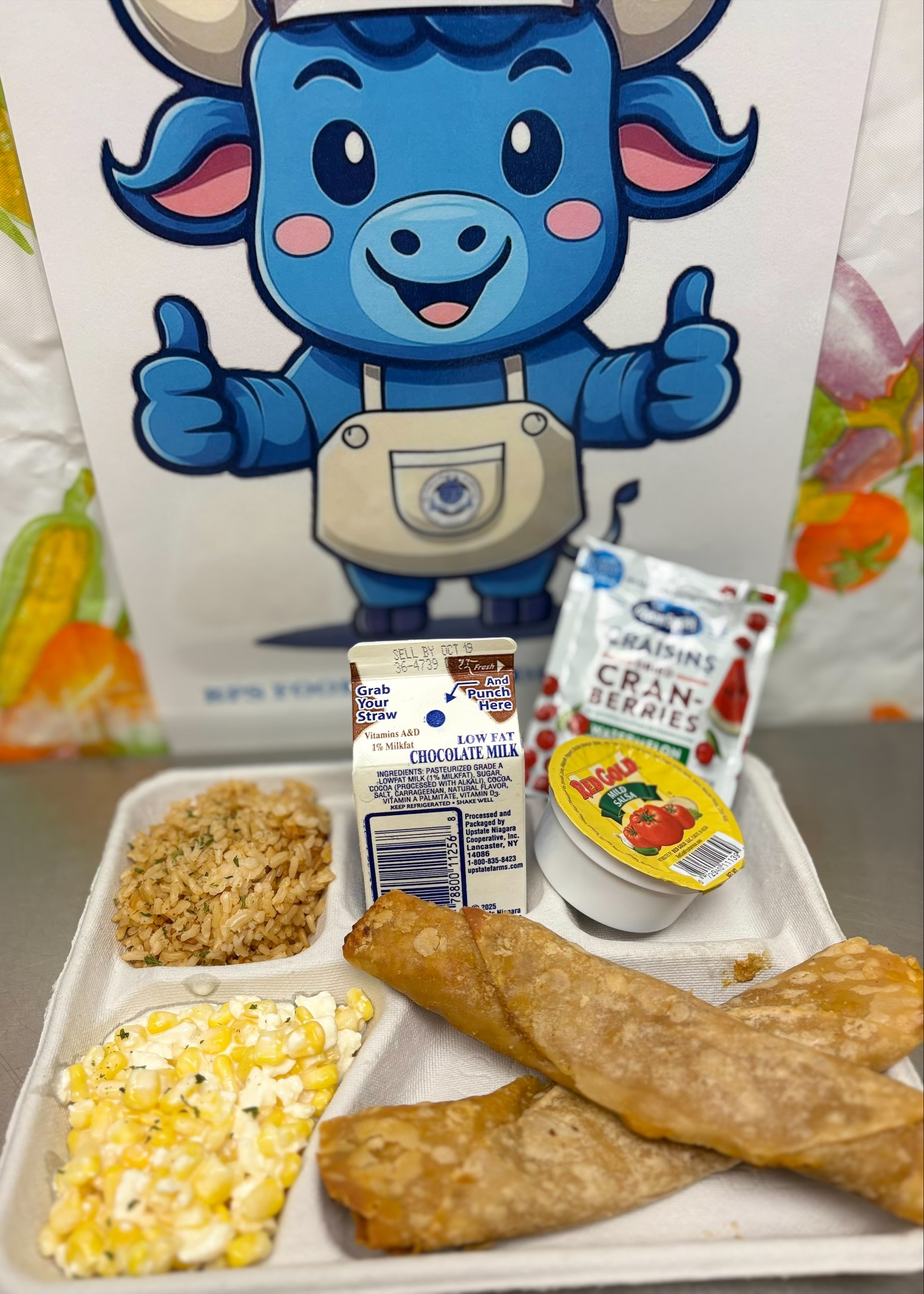 School 198- Lunch served on 10.7.2025 Chicken Crispito, Spanish Rice, Esquites, Salsa, Cranberries & Chocolate Milk