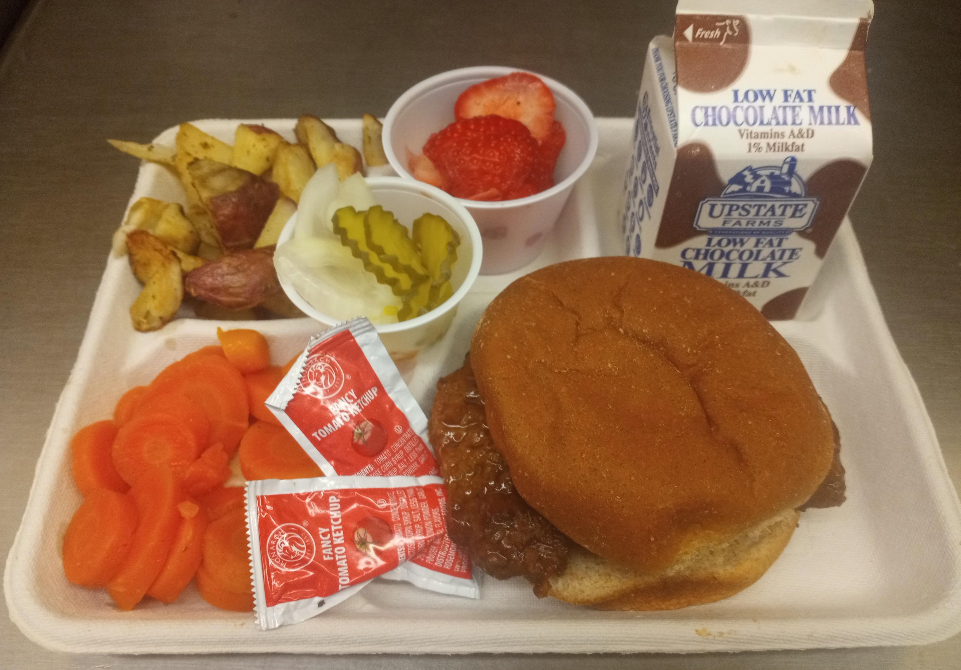 School 207- Lunch served on 10.8.25 BBQ Ribs on WG Burger Bun, Roasted Potatoes, Coin Carrots, Strawberries & Chocolate milk