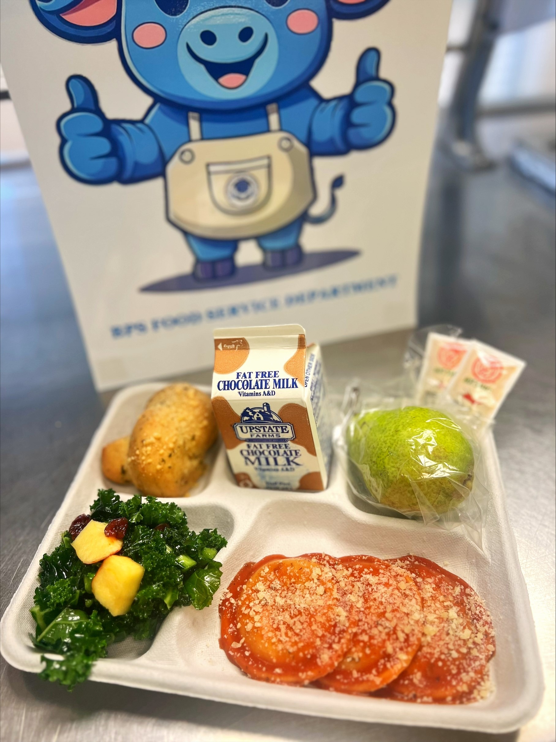 School 363- Lunch served on 10.9.25 Cheese Ravioli, Garlic Knot, NY Kale with Apples, Pear & Cholocale Milk