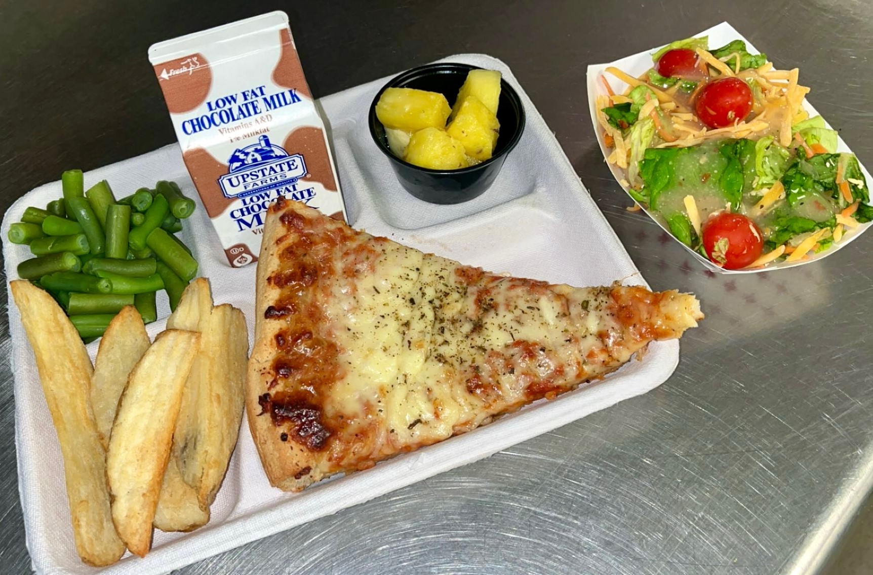 School 72- Lunch served on 10.9.25 Four Cheese Pizza, Potatoes Wedges, Vegetable Medley, Garden Salad, Pineapples & Chocolate Milk