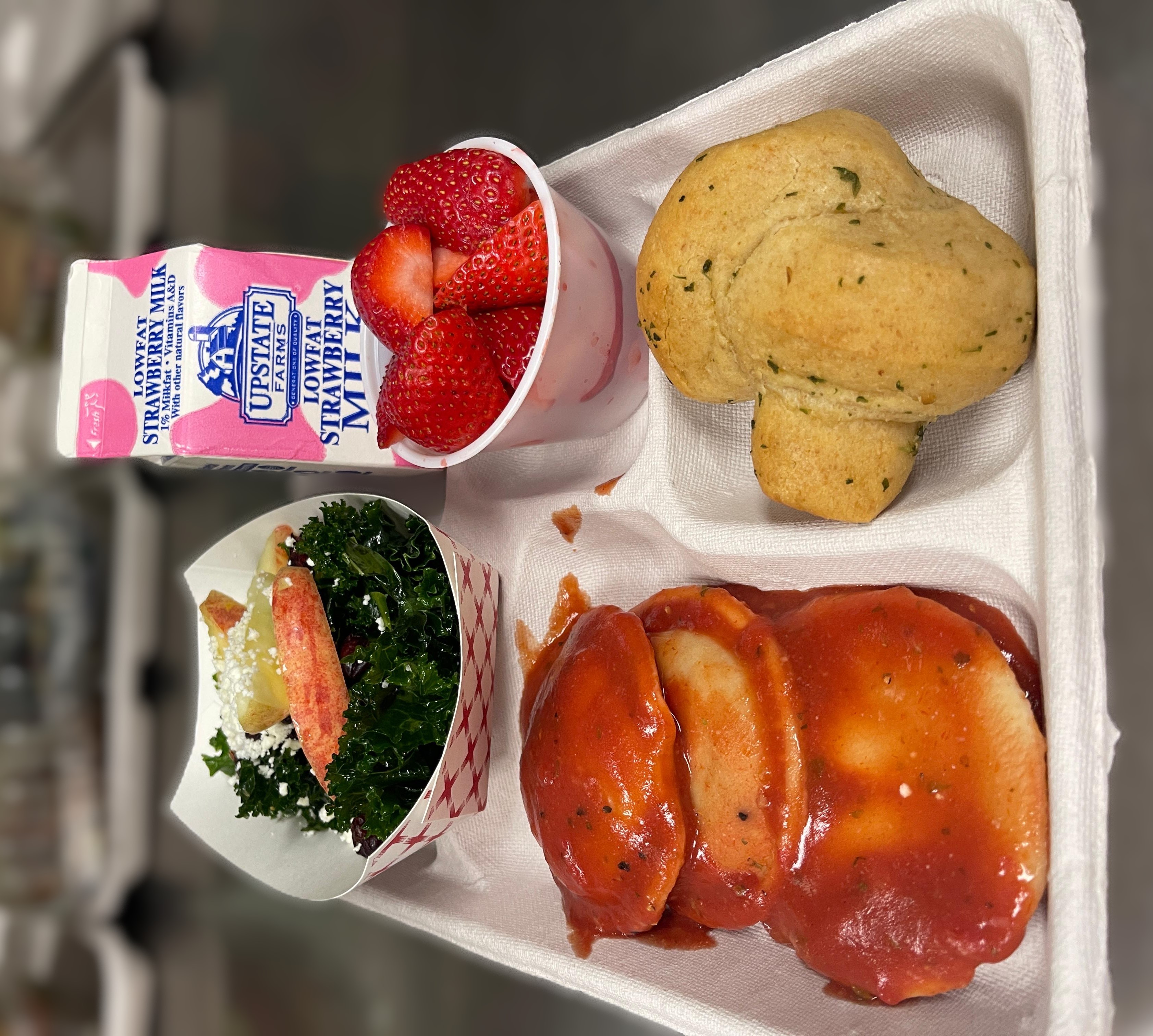 School 305- Lunch served on 10.9.25 Cheese Ravioli, Garlic Knot, NY Kale with Apples, Strawberries & Strawbery Milk