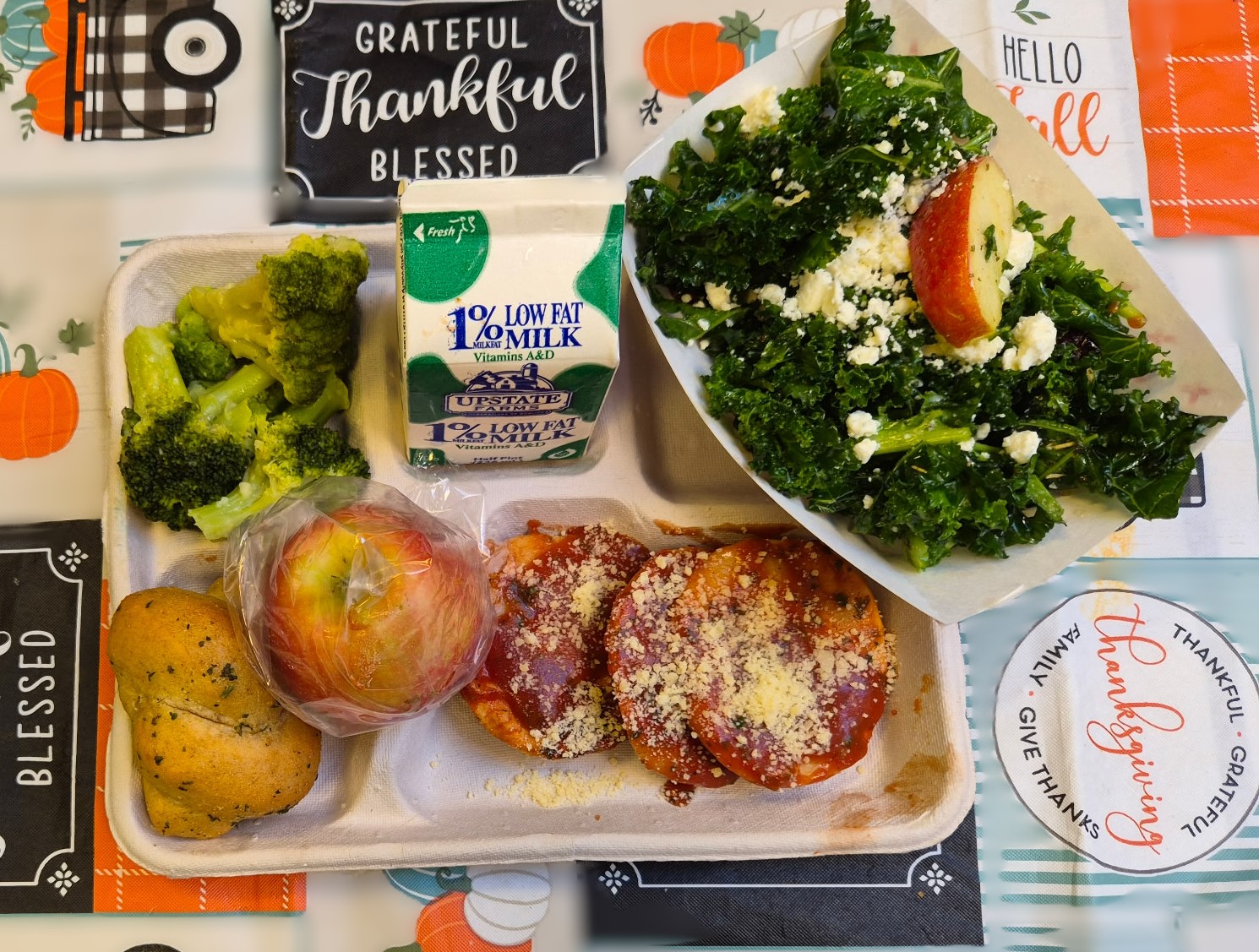 School 195- Lunch served on 10.9.25 Cheese Ravioli, Garlic Knot, NY Kale with Apples, Garlic Parmesan Roasted Broccoli, Apple & Milk