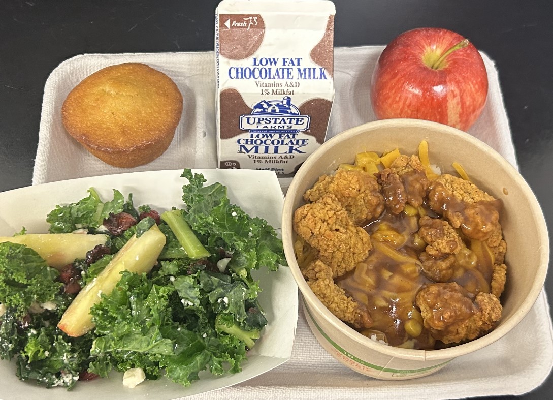 School 45 - Lunch served on 10.10.25 Popcorn Chicken, Mashed Potatoes, Sweet Corn, Corn Muffin, NY Kale Salad, Apple & Chocolate Milk