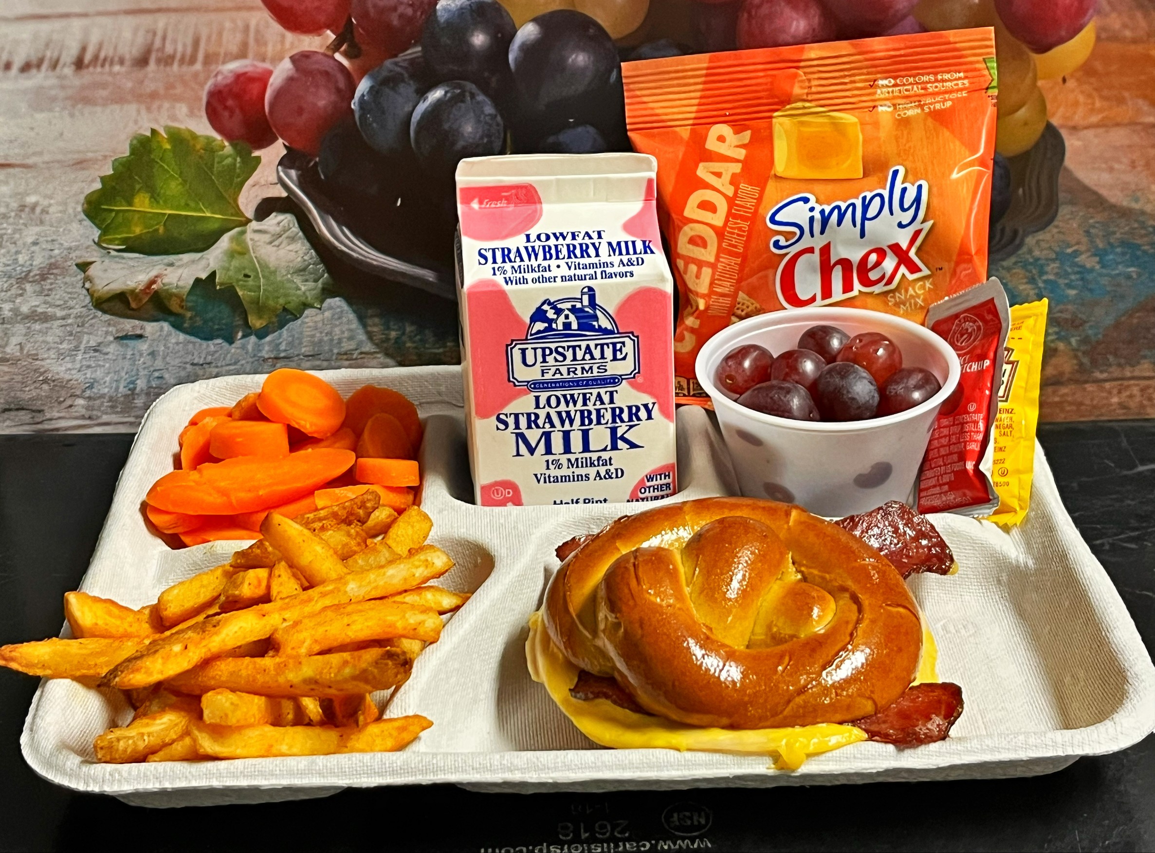School 205- Lunch served on 10.22.25 Turkey club melt on Pretzel Roll, French fries, Carrot coins, Grapes, Simple Chex & Strawberry Milk