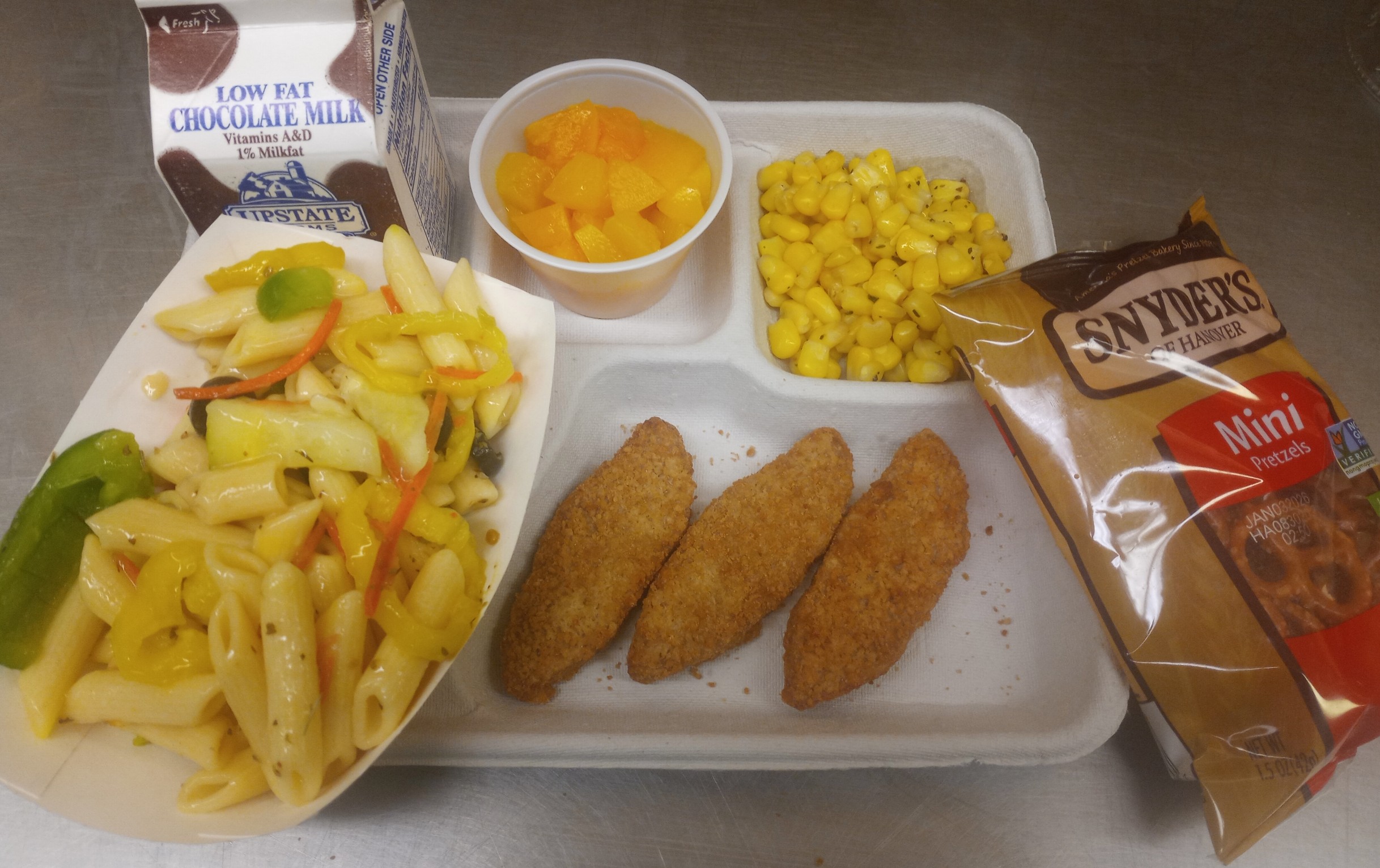 School 207- Lunch served on 10.23.25 Chicken Tenders, Pasta salad, Sweet Corn, Pretzels, Cupped Peaches & Chocolate Milk