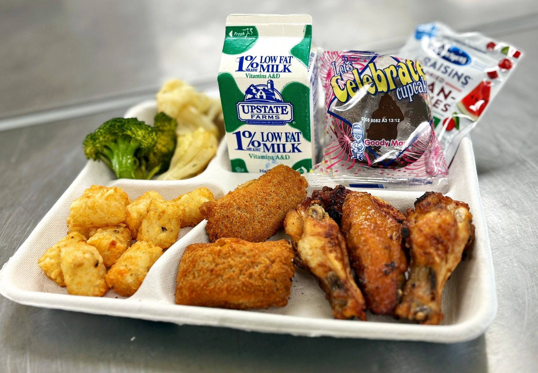 School 198- Lunch served on 10.24.25 Chicken Wings, Pizza Crunchers, Tater Tots, Roasted Broccoli &Cauliflower, Craisins, Creme Filled Chocolate Cupcake, Milk