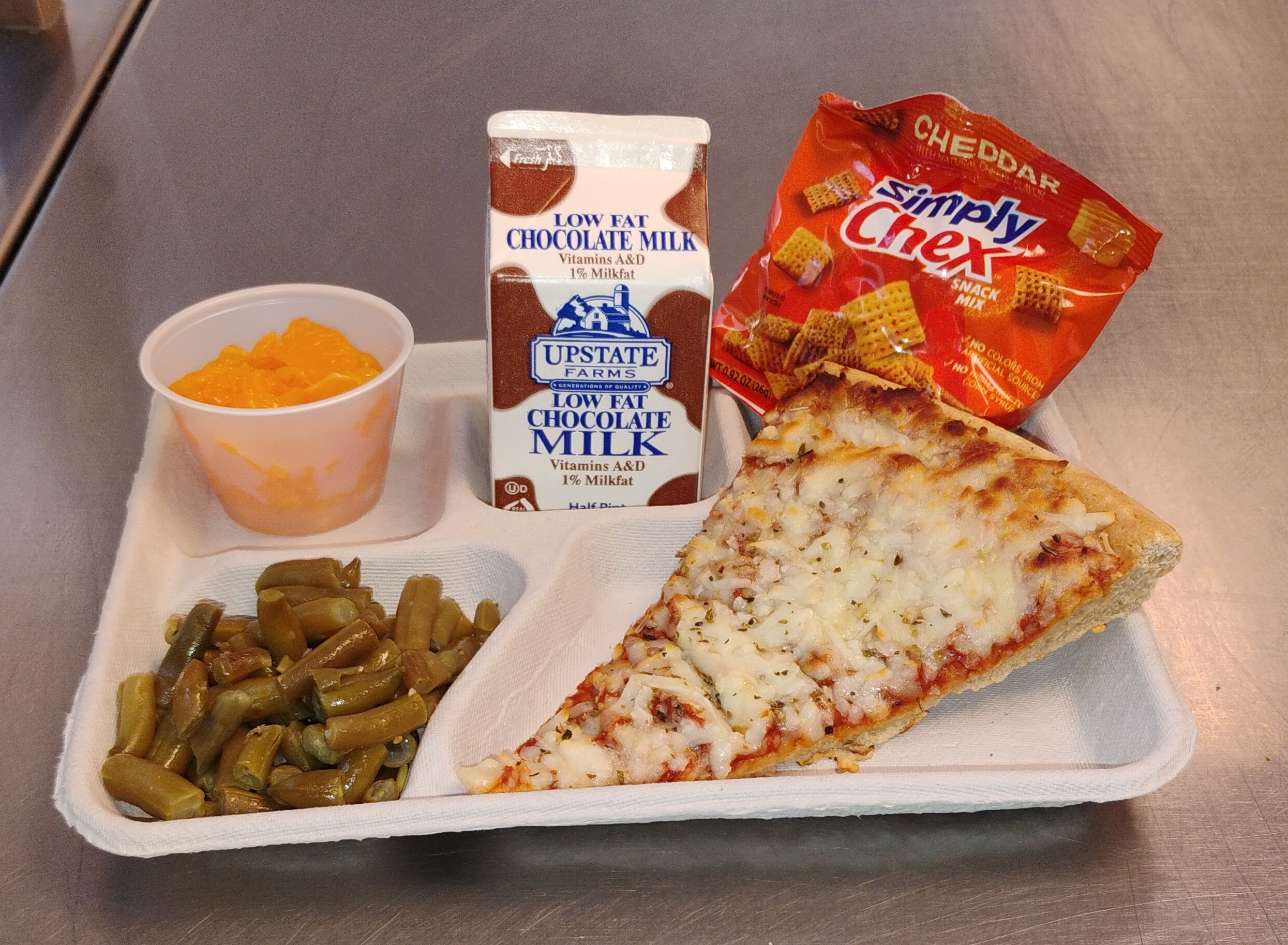 School 81- Lunch served on 10.27.25 Four Cheese Pizza, Green Beans,Cheddar Simply Chex, Cupped Peaches and Chocolate Milk