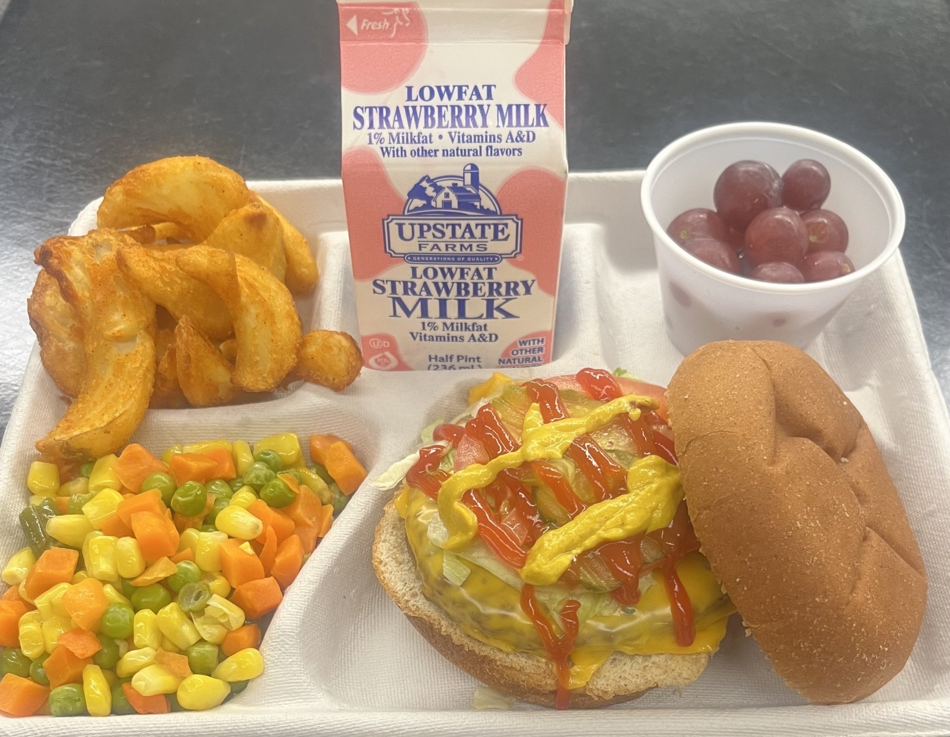 School 95- Lunch served on 10.28.25 Rodeo Burger WG Burger bun, Twister Taters, Vegetable Medley, Grapes and Strawberry Milk