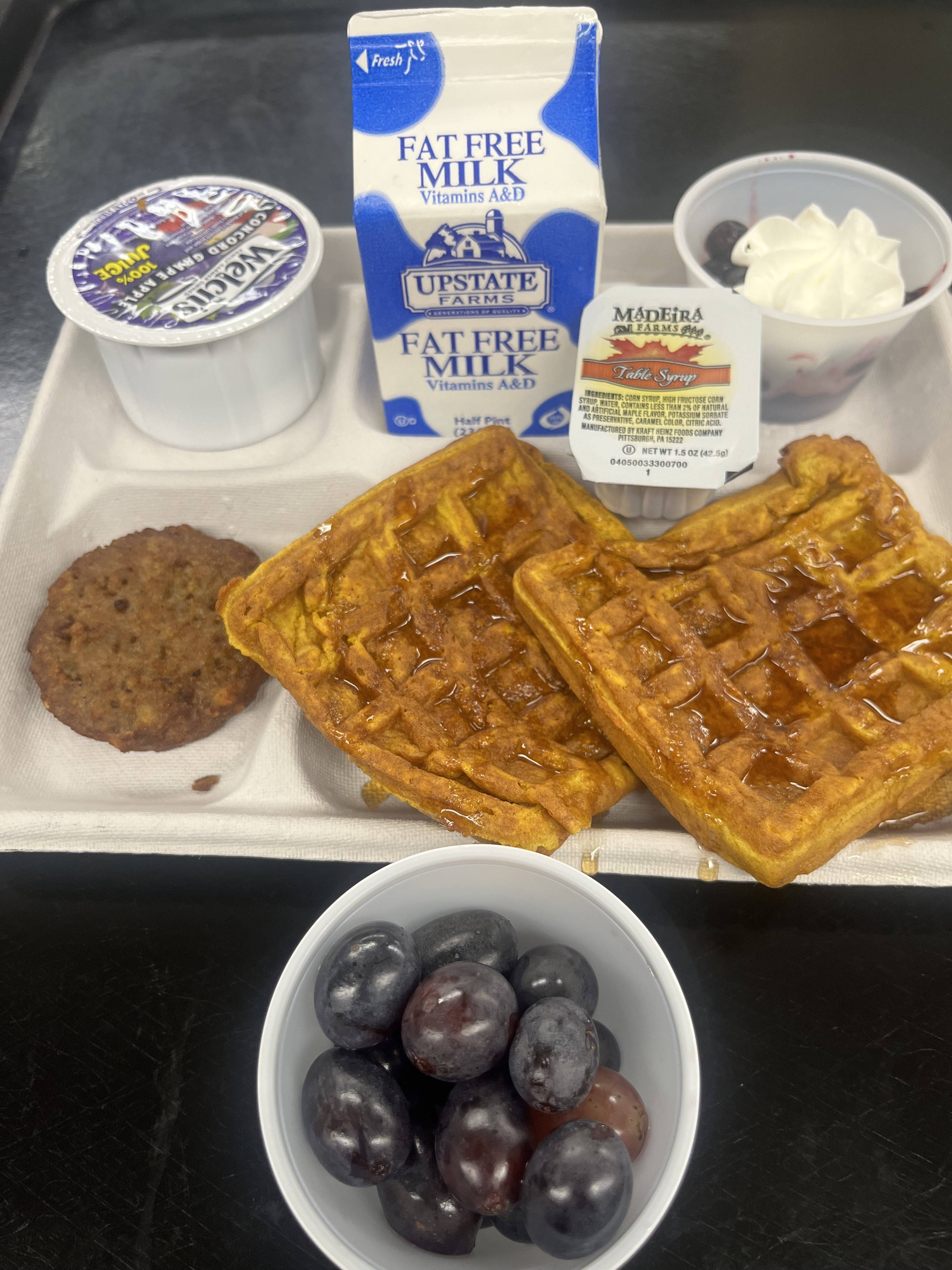 School 95 - Lunch served on 10.29.25 NY Carrot Waffles, Breakfast Sausage, Grapes, Grape Apple Juice, Mixed Berry Cup topped with Whipped Cream and Milk