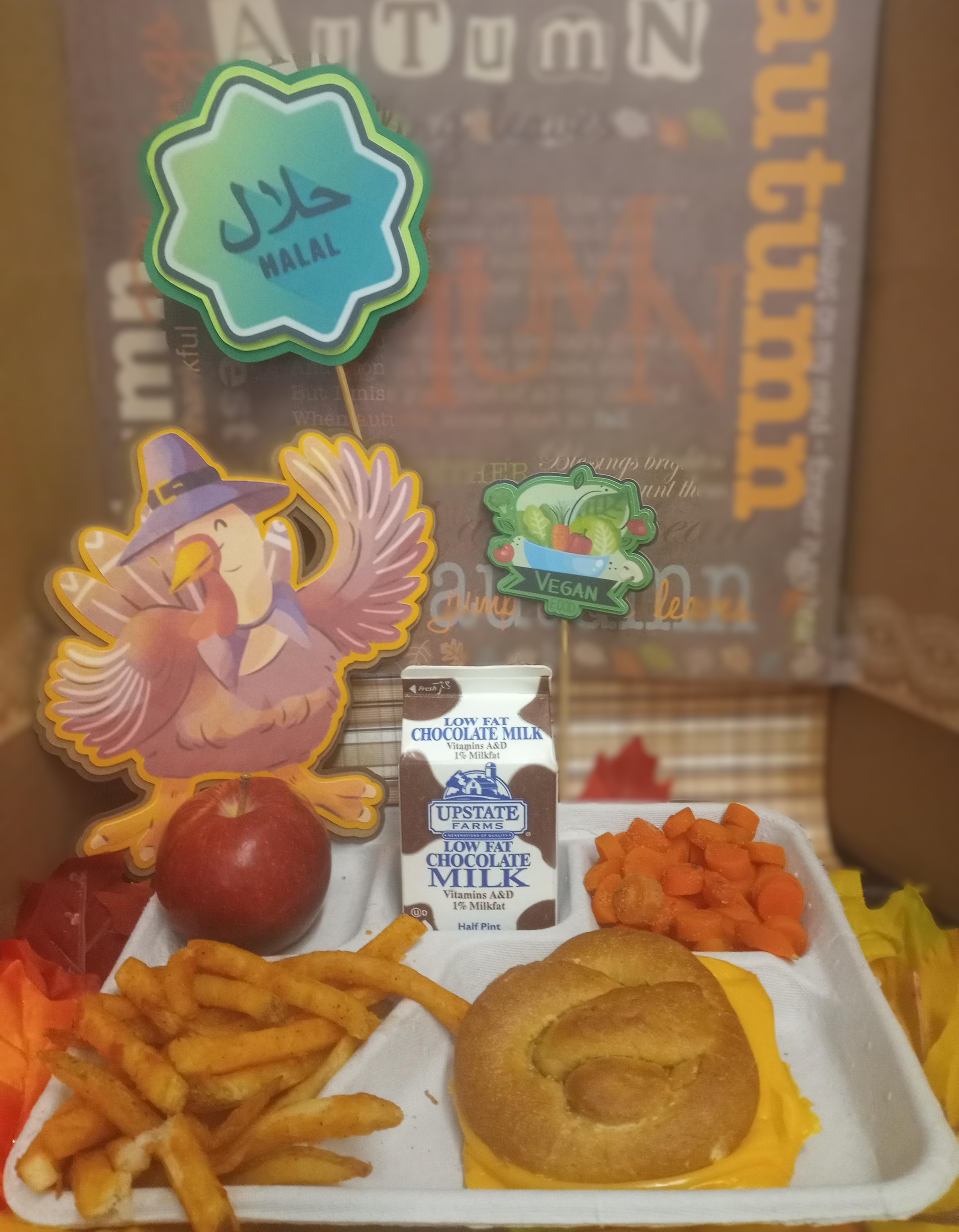 School 207- Lunch served on 11.12.25 Halal Turkey & Cheese Melt on Pretzel Bun, Carrots, French Fries, Apple and Chocolate Milk