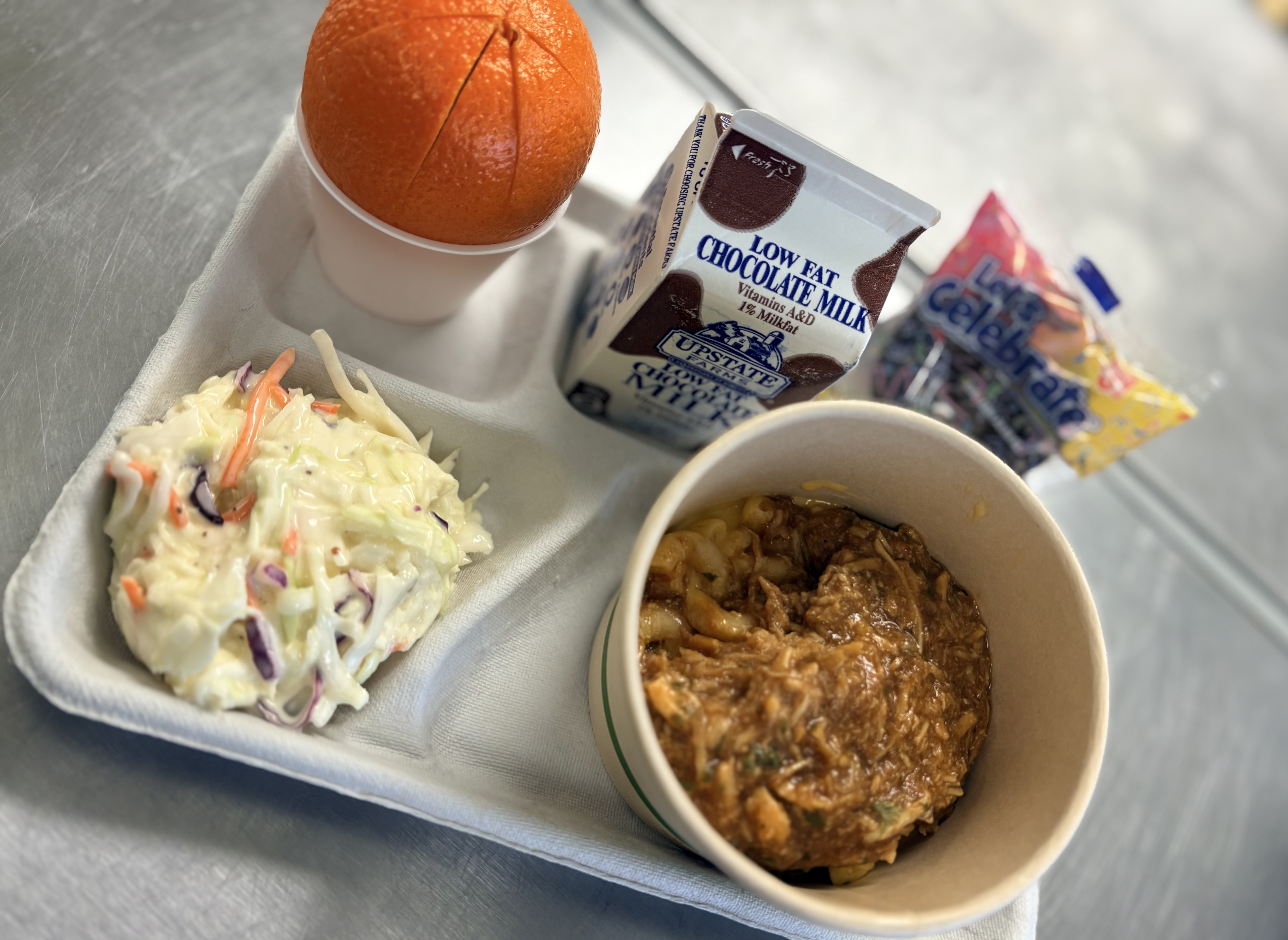 School 198- lunch served on 2.11.26 BBQ Chicken Mac and Cheese Bowl, Parmesan Cheese, orange, chocolate cupcake and chocolate milk